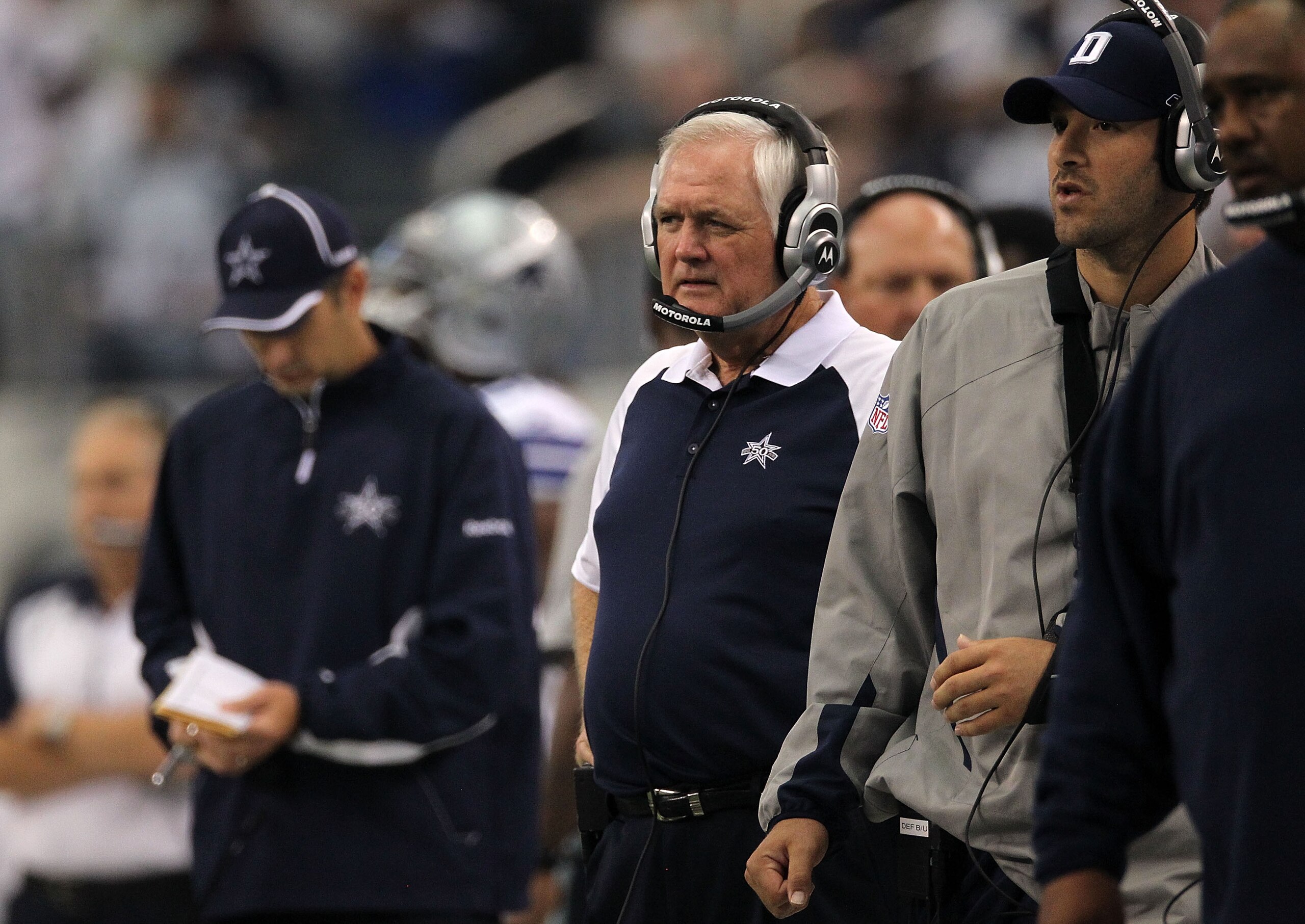 ARLINGTON, TX - OCTOBER 31:  Head coach Wade Phillips (C) and injured quarterback Tony Romo (R) of the Dallas Cowboys look on against the Jacksonville Jaguars at Cowboys Stadium on October 31, 2010 in Arlington, Texas.  (Photo by Ronald Martinez/Getty Ima