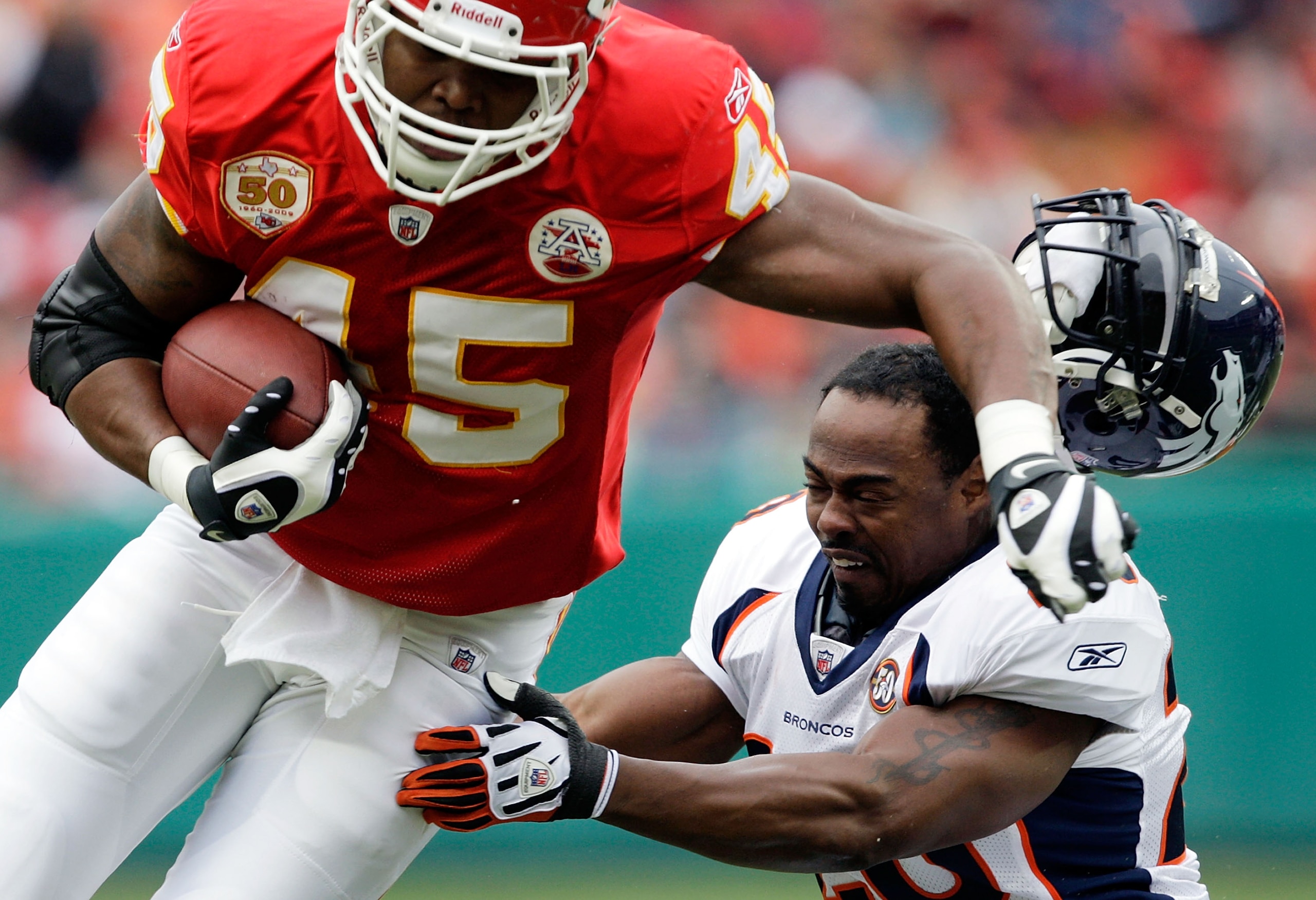 KANSAS CITY, MO - DECEMBER 06:  Safety Brian Dawkins #20 of the Denver Broncos loses his helmet as he persues Leonard Pope #45 of the Kansas City Chiefs during the game on December 6, 2009 at Arrowhead Stadium in Kansas City, Missouri.  (Photo by Jamie Sq