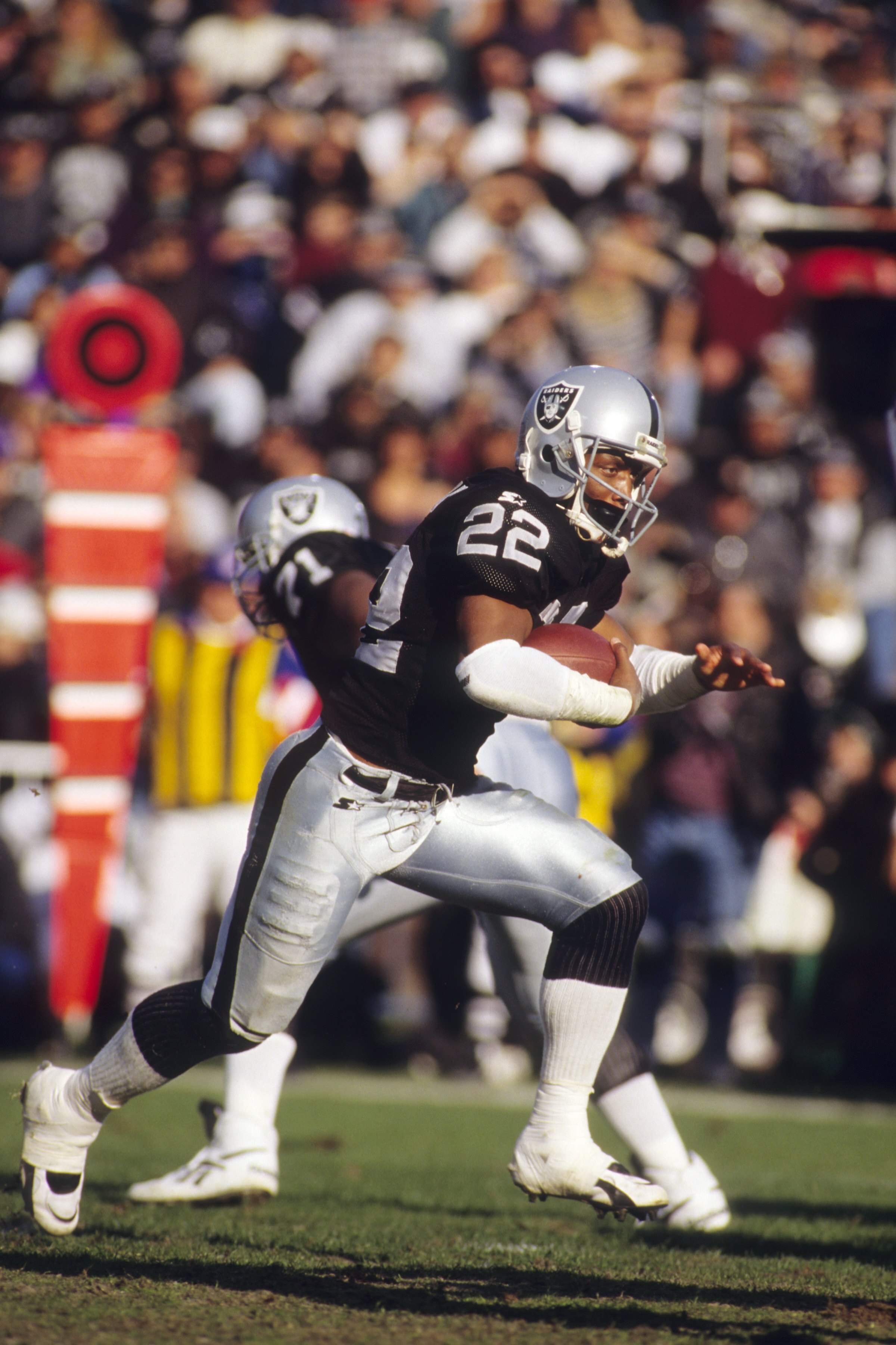 OAKLAND, CA - DECEMBER 24:  Running back Harvey Williams #22 of the Oakland Raiders runs with the ball during the game against the Denver Broncos at the Oakland/Alameda County Coliseum on December 24, 1995 in Oakland, California.  The Denver Broncos won 3