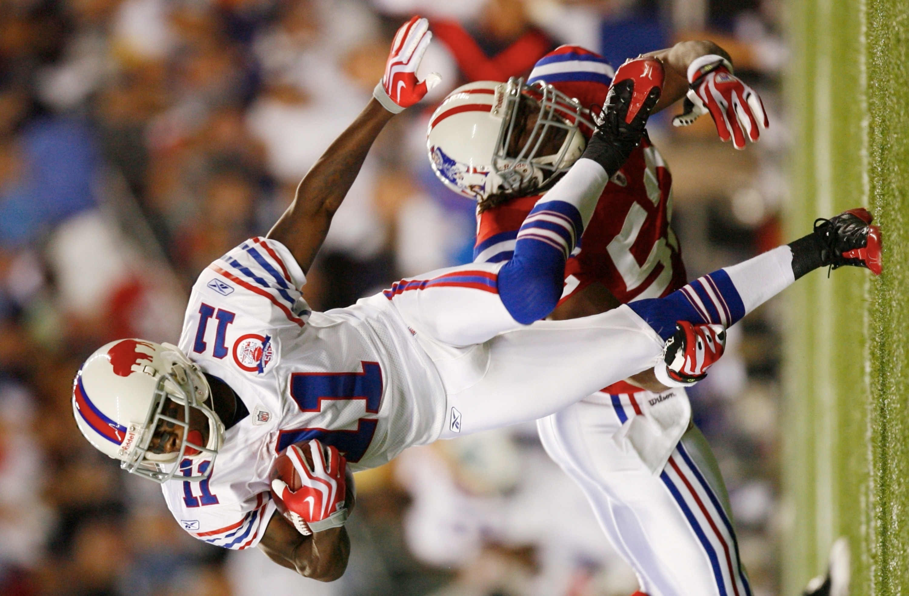 FOXBORO, MA - SEPTEMBER 14:  Eric Alexander #52 of the New England Patriots tries to stop wide receiver Roscoe Parrish #11 of the Buffalo Bills as he carries the ball during the second quarter on September 14, 2009 at Gillette Stadium in Foxboro, Massachu