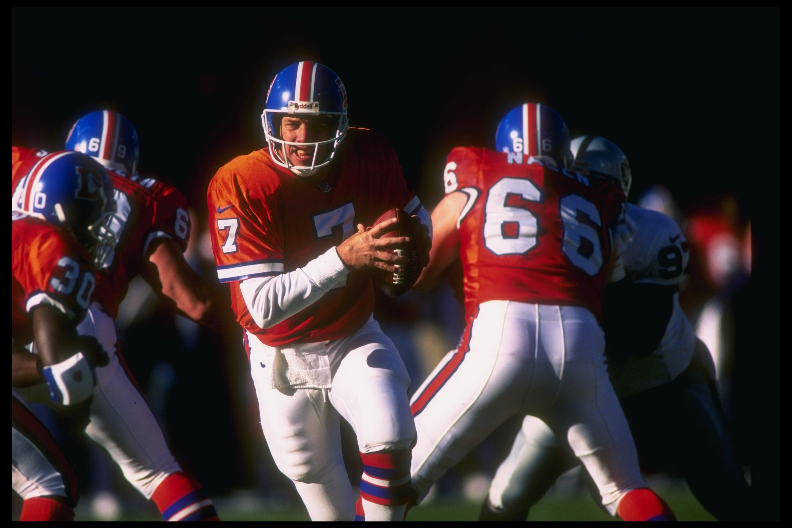 15 Dec 1996: Quarterback John Elway of the Denver Broncos moves the ball during a game against the Oakland Raiders at Mile High Stadium in Denver, Colorado. The Broncos won the game, 24-19.