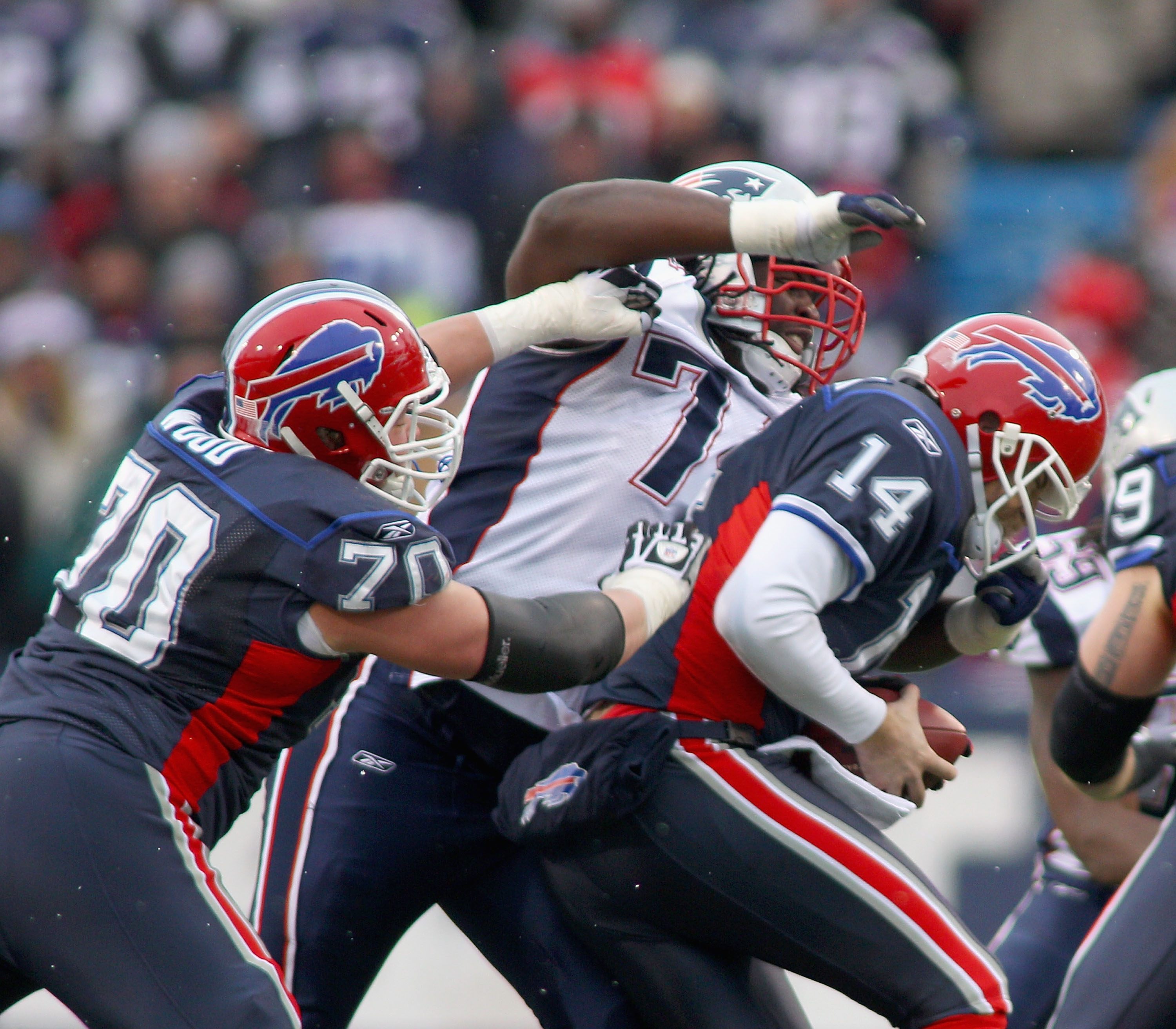 ORCHARD PARK, NY - DECEMBER 26:  Kyle Love #74  of the New England Patriots sacks Ryan Fitzpatrick #14 of the Buffalo Bills as Eric Wood #70 of the Bills tries to block at Ralph Wilson Stadium on December 26, 2010 in Orchard Park, New York. New England wo