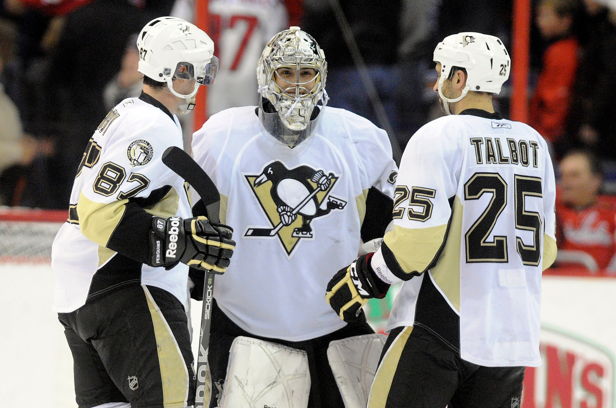 WASHINGTON, DC - DECEMBER 23:  Marc-Andre Fleury #29 of the Pittsburgh Penguins is congratulated by Sidney Crosby #87 and Maxime Talbot #25 after a 3-2 shootout victory against the Washington Capitals  at the Verizon Center on December 23, 2010 in Washing