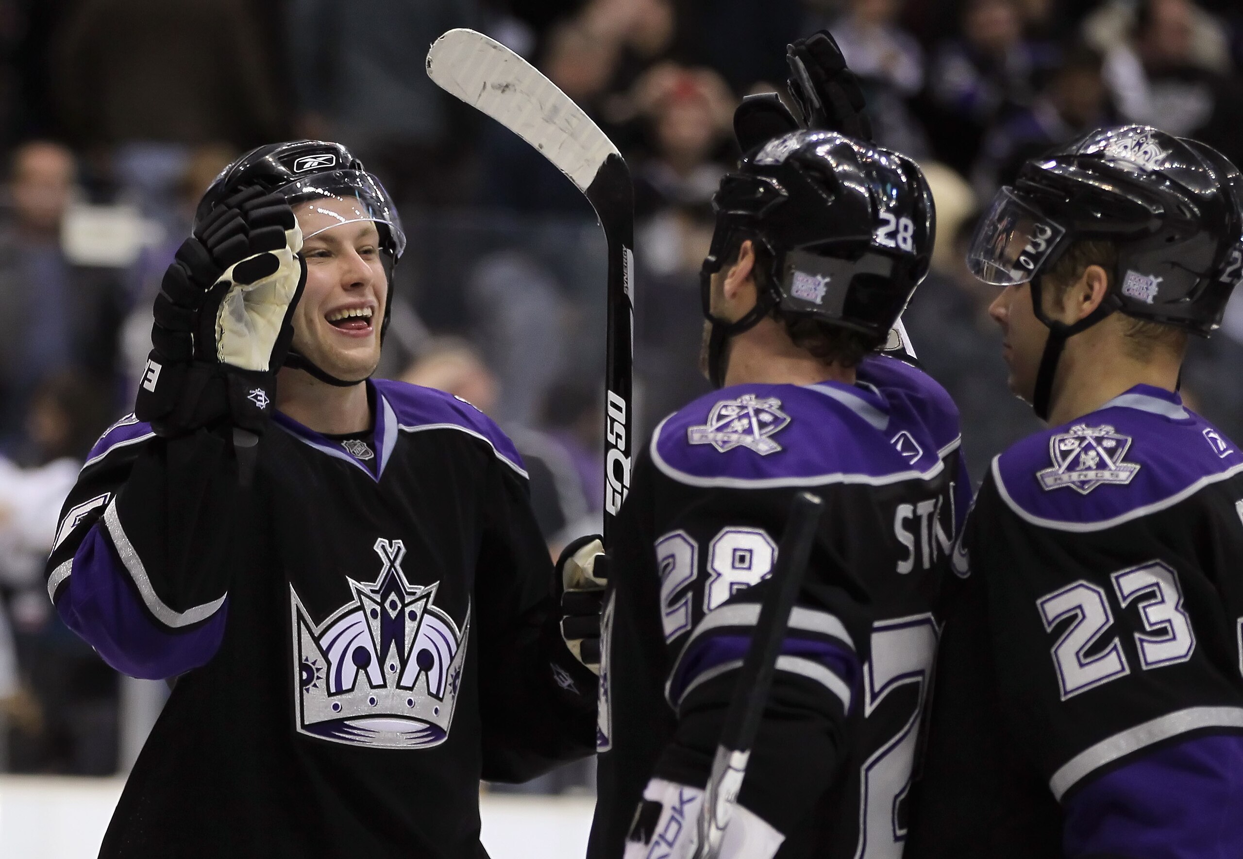 LOS ANGELES, CA - OCTOBER 30:  (L-R) Jake Muzzin #6, Jarret Stoll #28 and Dustin Brown #23 of the Los Angeles Kings celebrate their teams victory over the New Jersey Devils at Staples Center on October 30, 2010 in Los Angeles, California. The Kings defeat
