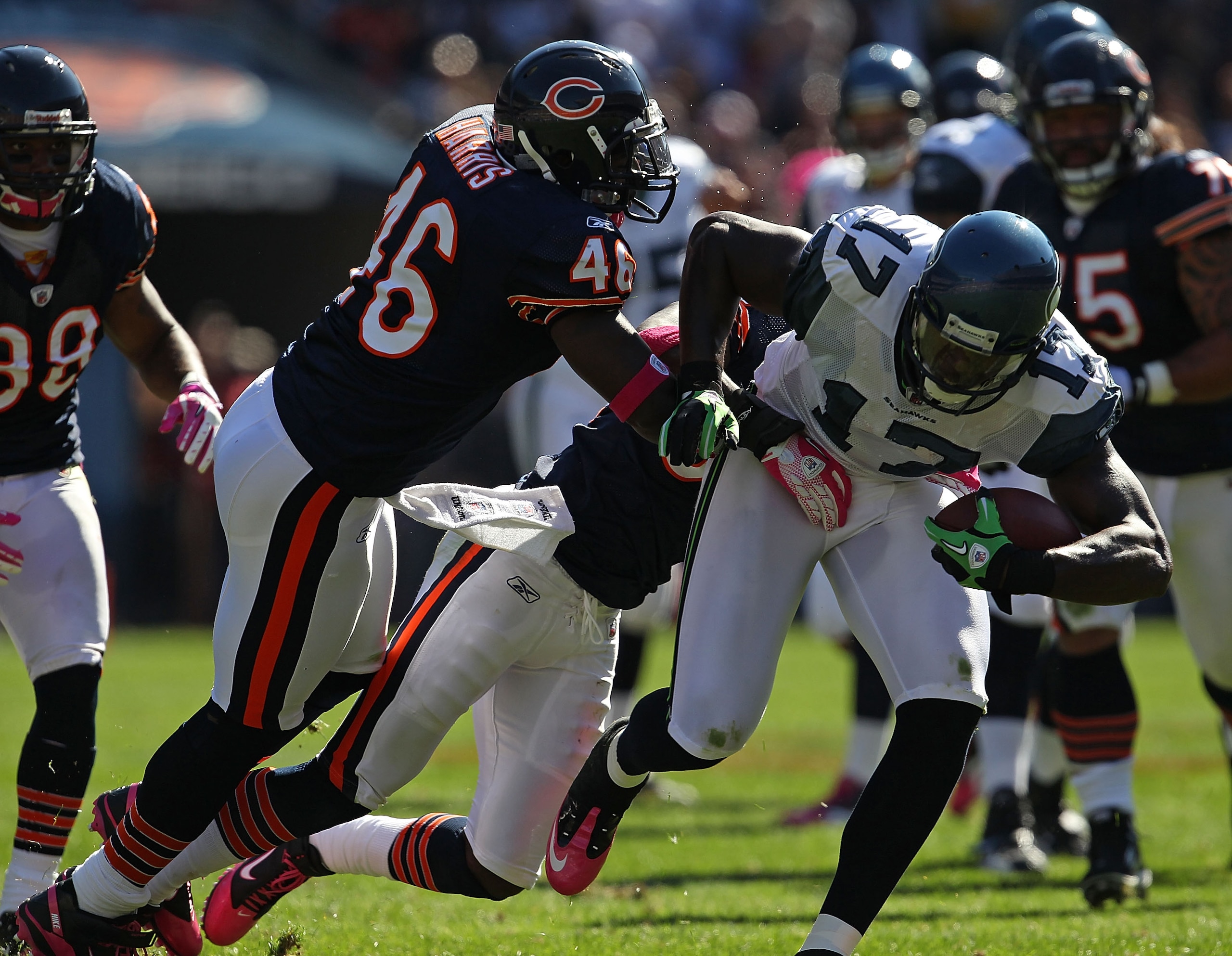 CHICAGO - OCTOBER 17: Mike Williams #17 of the Seattle Seahawks runs for a first down while being grabbed by Chris Harris #46 and Charles Tillman #33 of the Chicago Bears at Soldier Field on October 17, 2010 in Chicago, Illinois. (Photo by Jonathan Daniel