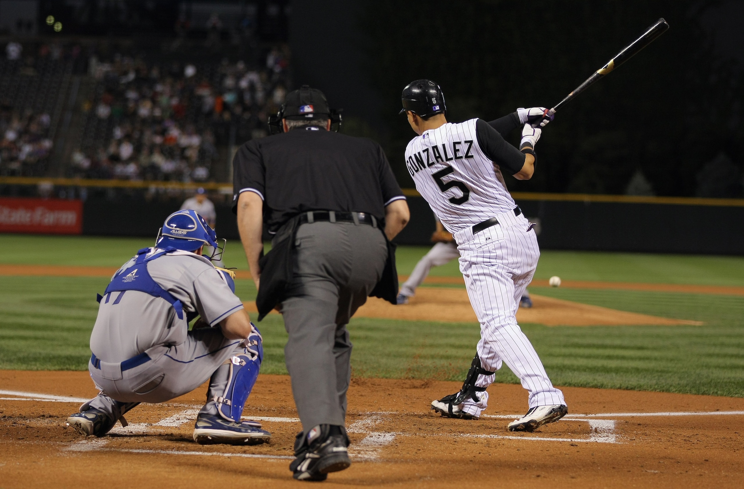 DENVER - SEPTEMBER 27:  Carlos Gonzalez #5 of the Colorado Rockies takes an at bat against the Los Angeles Dodgers at Coors Field on September 25, 2010 in Denver, Colorado. The Dodgers defeated the Rockies 3-1.  (Photo by Doug Pensinger/Getty Images)