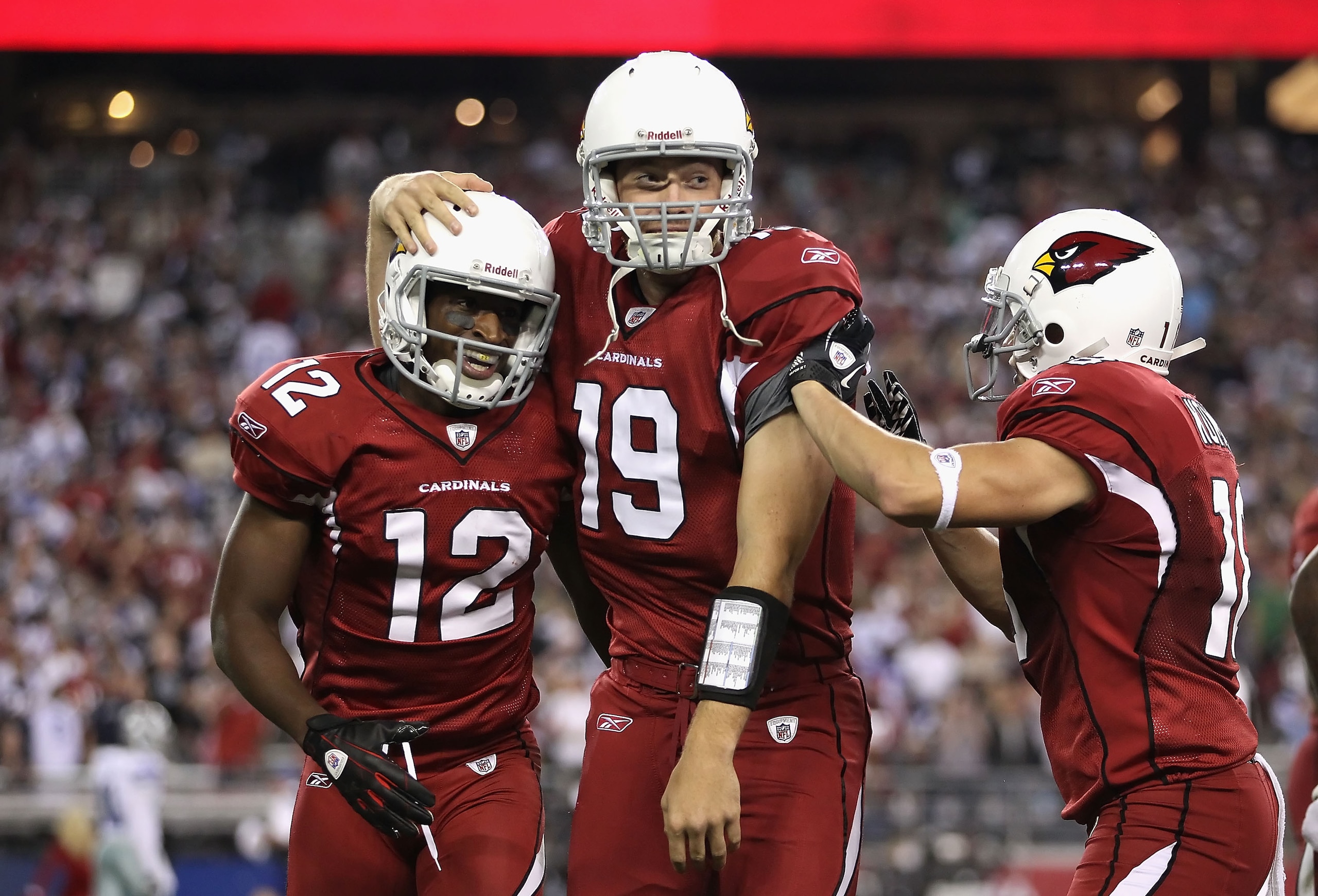 GLENDALE, AZ - DECEMBER 25: Wide receiver Andre Roberts #12 of the Arizona Cardinals celebrates with quarterback John Skelton #19 after scoring on a 74 yard touchdown reception against the Dallas Cowboys during the second quarter of the NFL game at the Un GLENDALE, AZ - DECEMBER 25: Wide receiver Andre Roberts #12 of the Arizona Cardinals celebrates with quarterback John Skelton #19 after scoring on a 74 yard touchdown reception against the Dallas Cowboys during the second quarter of the NFL game at the Un