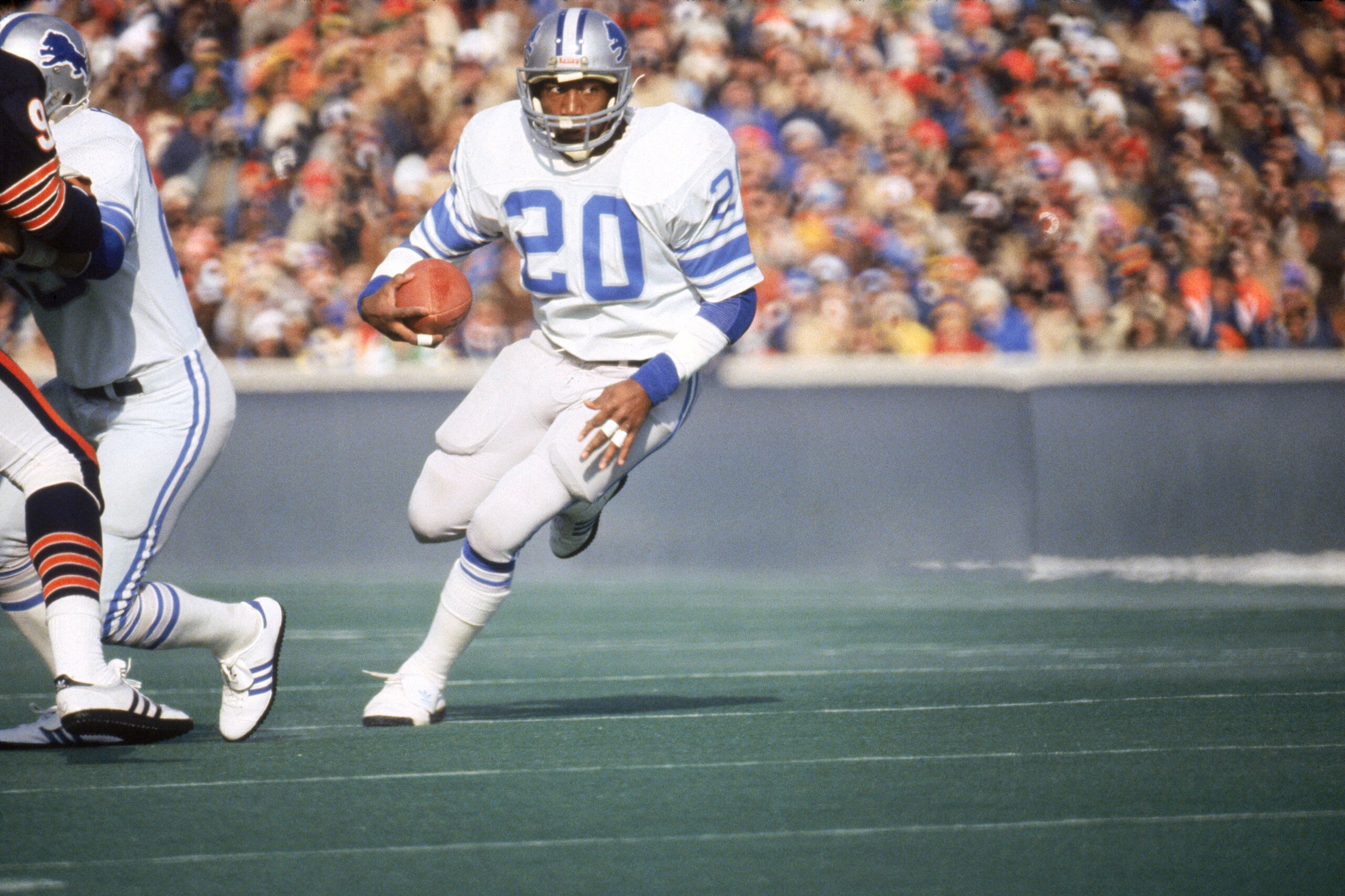 CHICAGO - DECEMBER 1981:  Running back Billy Sims #20 of the Detroit Lions rushes for yards against the Chicago Bears during a NFL game circa December of 1981 at Soldier Field in Chicago, Illinois.  The Cardinals won 17-10.  (Photo by Jonathan Daniel/Gett
