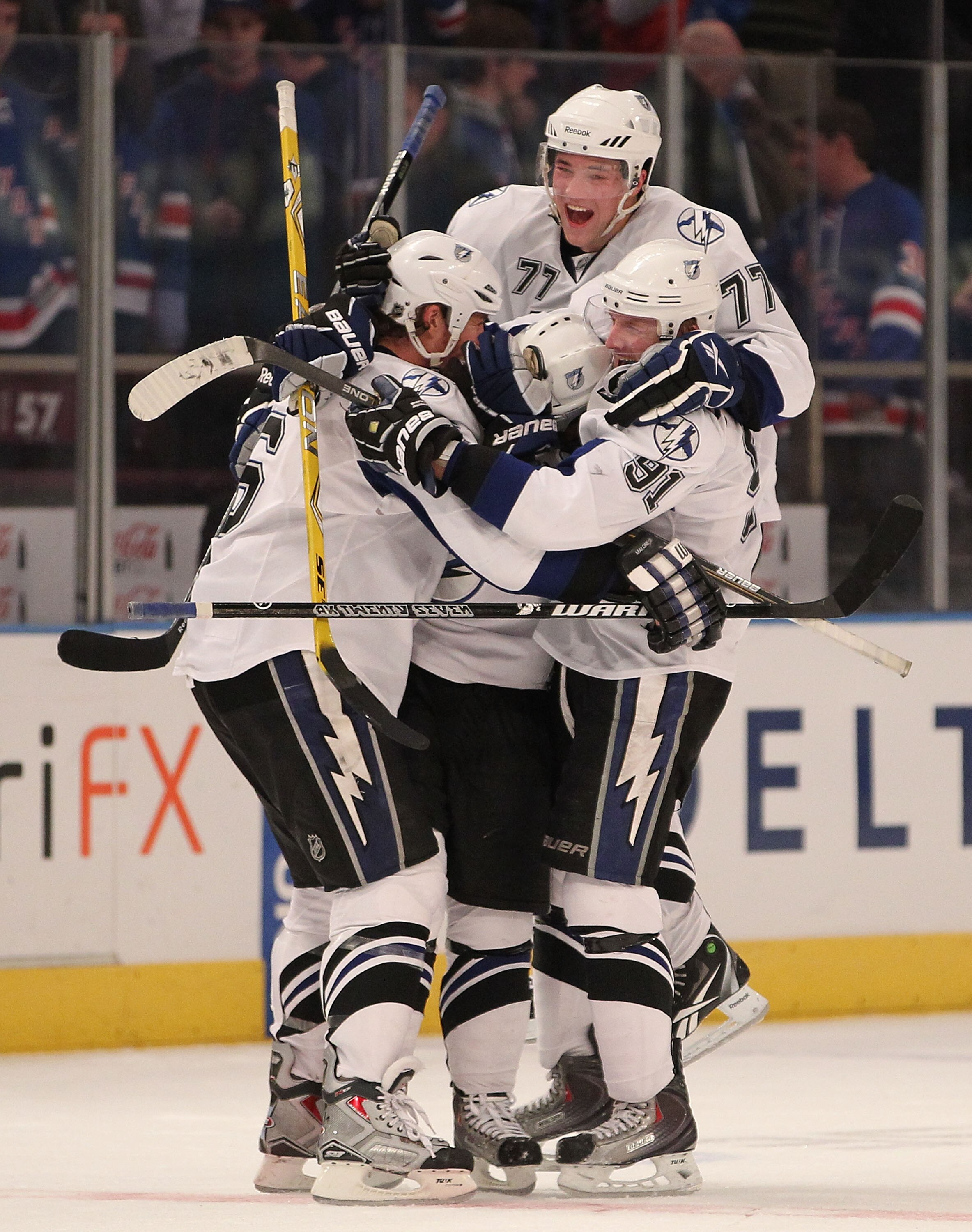 NEW YORK, NY - DECEMBER 23:  Victor Hedman #77 and Steven Stamkos #91 of the Tampa Bay Lightning mob teammate Ryan Malone #6 after Malone scored the game winning goal during the shootout in an NHL hockey game against the New York Rangers at Madison Square