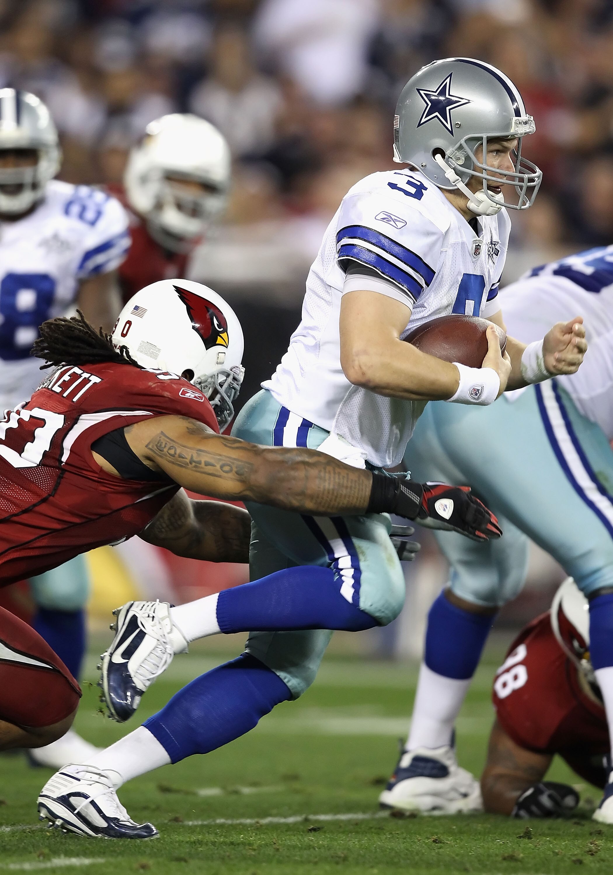 GLENDALE, AZ - DECEMBER 25:  Quarterback Jon Kitna #3 of the Dallas Cowboys is sacked by Darnell Dockett #90 of the Arizona Cardinals during the second quarter of the NFL game at the University of Phoenix Stadium on December 25, 2010 in Glendale, Arizona.