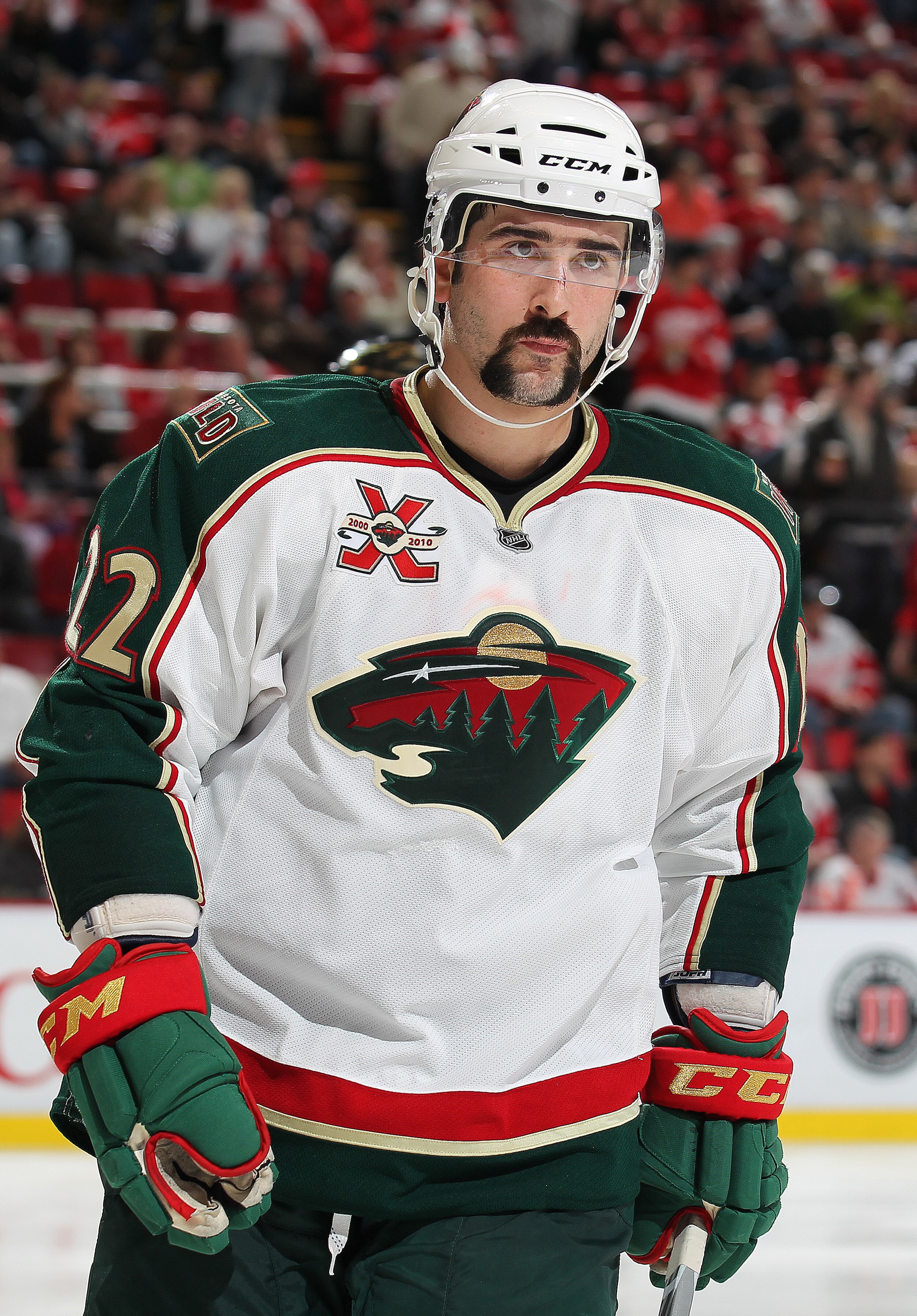 DETROIT, MI - NOVEMBER 19:  Cal Clutterbuck #22 of the Minnesota Wild gets set for a faceoff in a game against the Detroit Red Wings on November 19, 2010 at the Joe Louis Arena in Detroit, Michigan. The Wild defeated the Wings 4-3 in overtime. (Photo by C