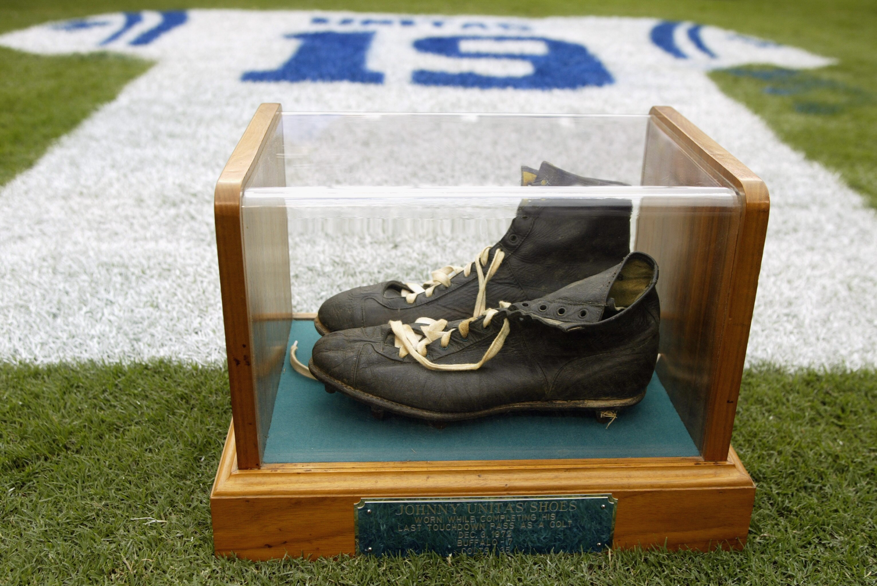 BALTIMORE - SEPTEMBER  15:  Detail of an onfield tribute to Hall of Fame quarterback Johnny Unitas #19 of the Baltimore Colts with his signature black high tops in a glass case during halftime of the NFL game between the Tampa Bay Buccaneers and the Balti