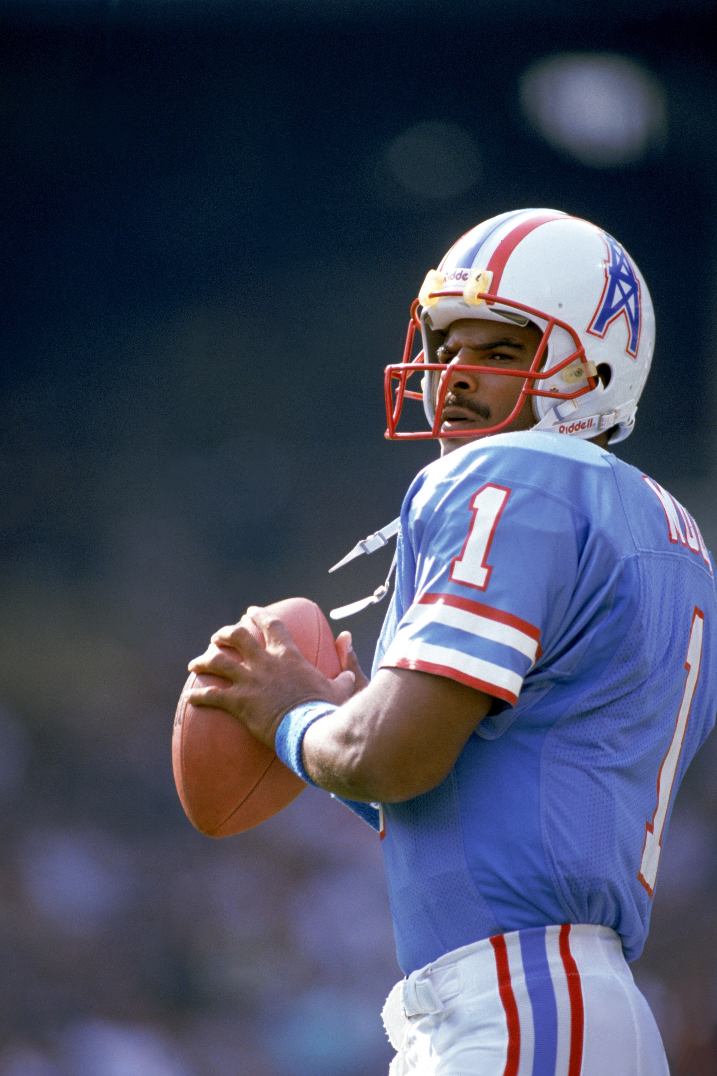CLEVELAND - OCTOBER 29:  Quarterback Warren Moon #1 of the Houston Oilers sets to pass during an NFL game against the Cleveland Browns at Cleveland Stadium on October 29, 1989 in Cleveland, Ohio.  The Browns won 28-17.  (Photo by Brian Masck/Getty Images)
