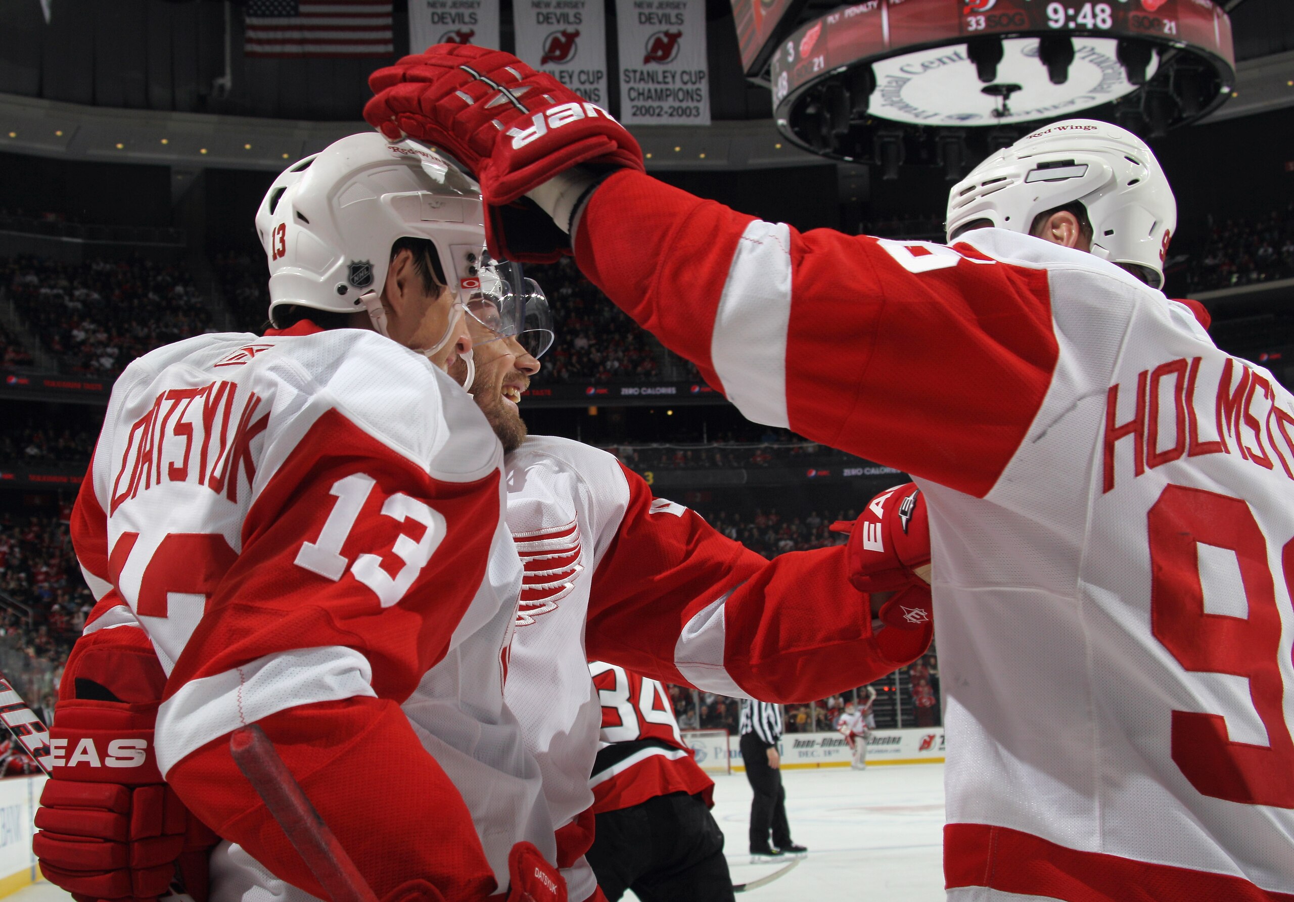NEWARK, NJ - DECEMBER 11: Pavel Datsyuk #13 of the Detroit Red Wings is congratulated by Tomas Holmstrom #96 on his goal at 10:26 of the third period against the New Jersey Devils at the Prudential Center on December 11, 2010 in Newark, New Jersey. The Re