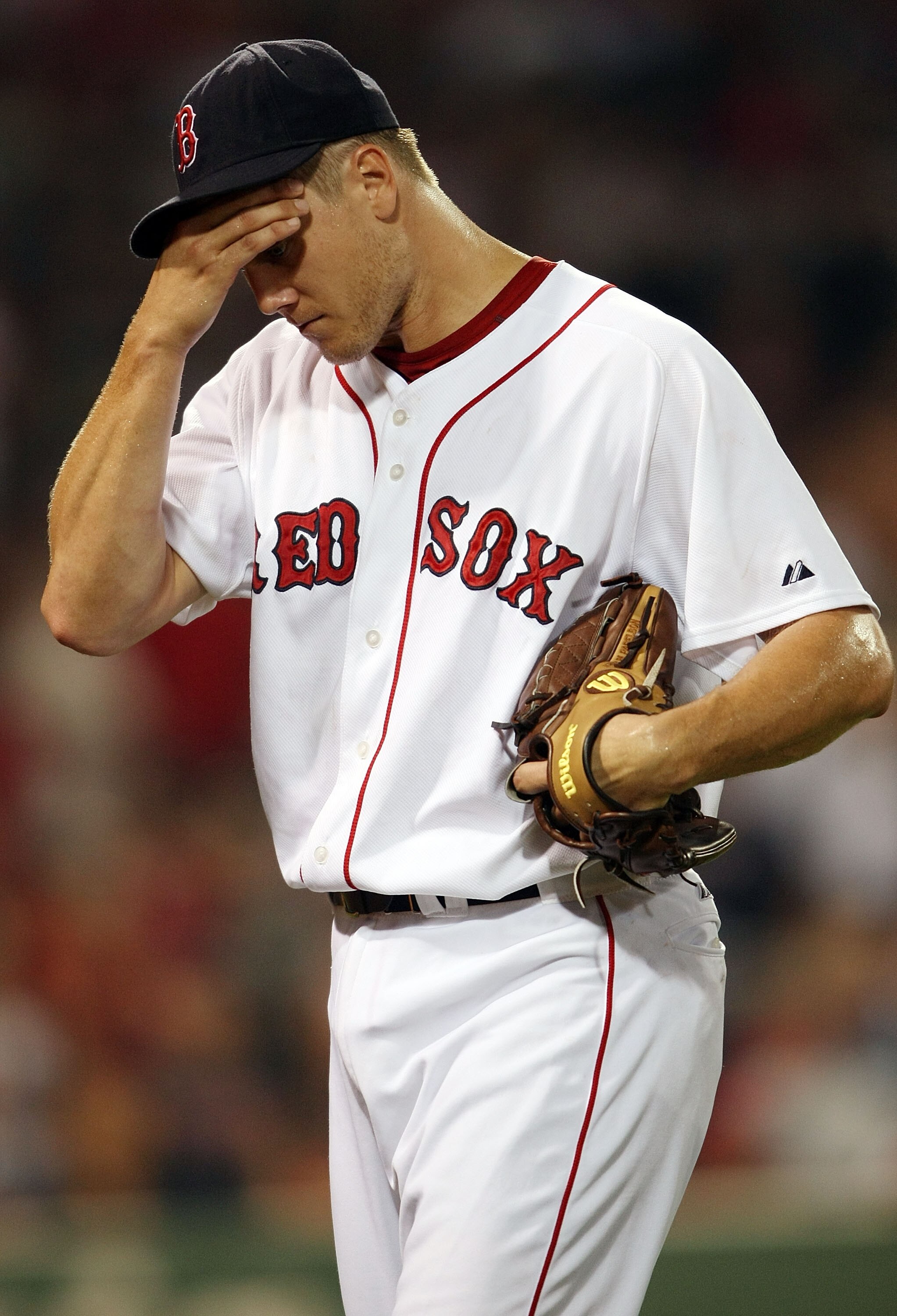 BOSTON - JULY 28:  Jonathan Papelbon #58 of the Boston Red Sox heads to the dugout after an error in the ninth inning against the Oakland Athletics at Fenway Park July 28, 2009 in Boston, Massachusetts.  (Photo by Elsa/Getty Images)
