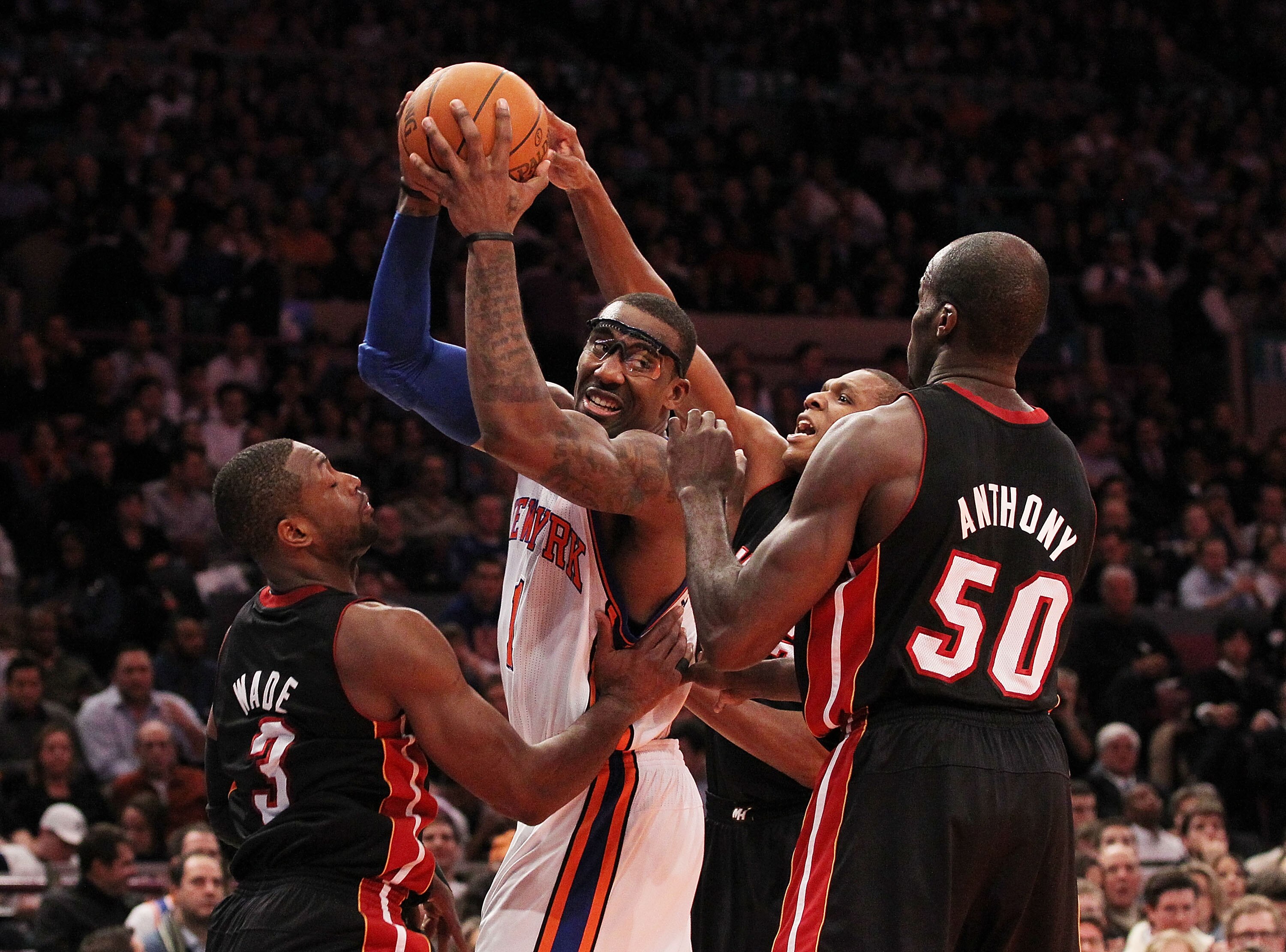 NEW YORK, NY - DECEMBER 17:  Amar'e Stoudemire #1 of the New York Knicks is surrounded by Dwyane Wade #3 and Joel Anthony #50 of the Miami Heat at Madison Square Garden on December 17, 2010 in New York City. NOTE TO USER: User expressly acknowledges and a