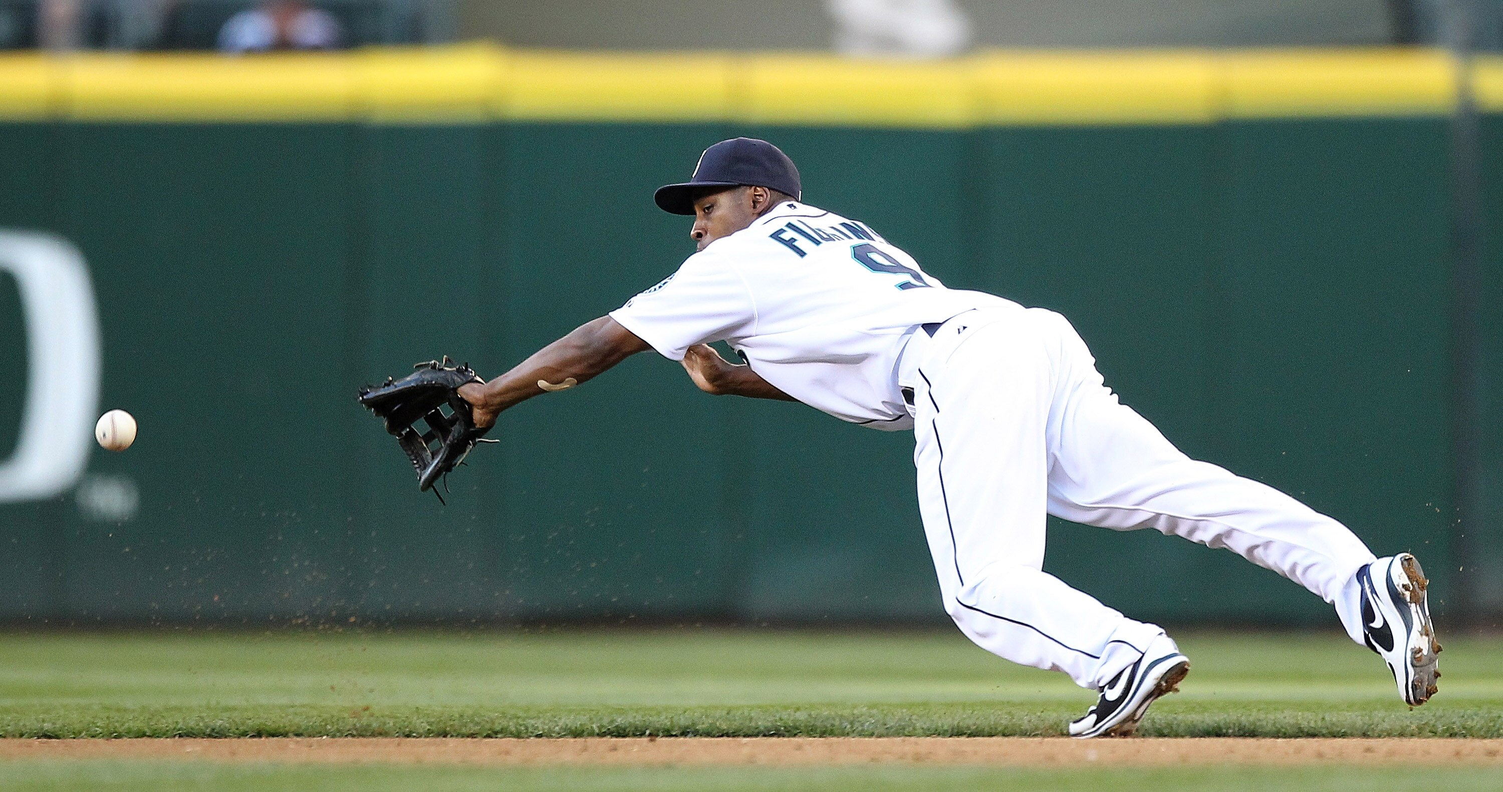 SEATTLE - JULY 24:  Chone Figgins #9 of the Seattle Mariners dives for a line drive hit by Marco Scutaro #16 of the Boston Red Sox at Safeco Field on July 24, 2010 in Seattle, Washington. (Photo by Otto Greule Jr/Getty Images)