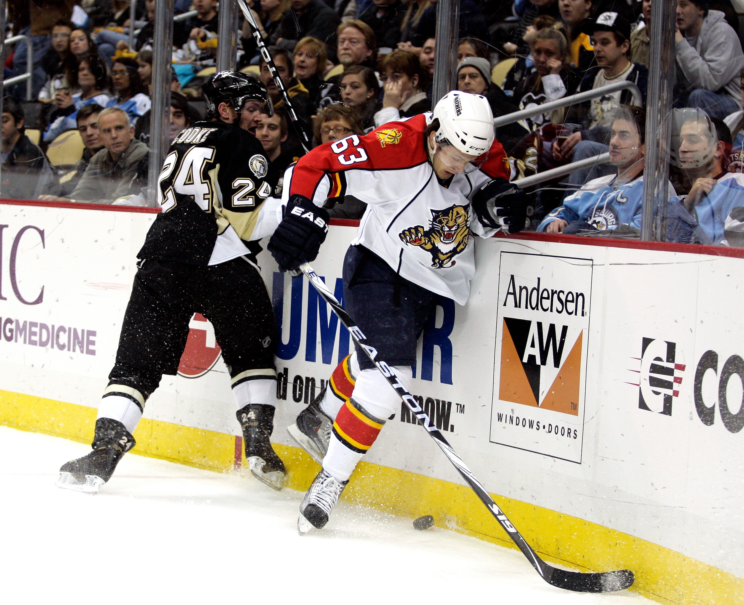 PITTSBURGH, PA - DECEMBER 22:  Evgeni Dadonov #63 of the Florida Panthers battles in the corner with Matt Cooke #24 of the Pittsburgh Penguins at Consol Energy Center on December 22, 2010 in Pittsburgh, Pennsylvania.  (Photo by Justin K. Aller/Getty Image