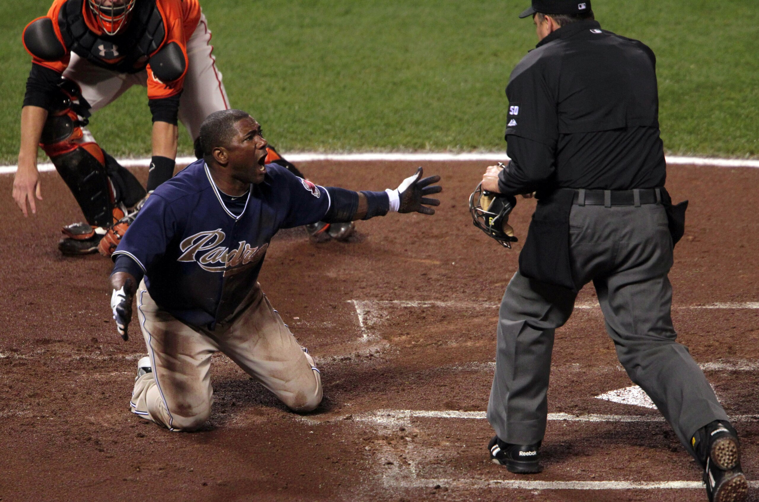 SAN FRANCISCO - OCTOBER 01:  Miguel Tejada #10 of the San Diego Padres reacts after being tagged out at home plate by Buster Posey #28 of the San Francisco Giants during the first inning at AT&T Park on October 1, 2010 in San Francisco, California.  (Phot