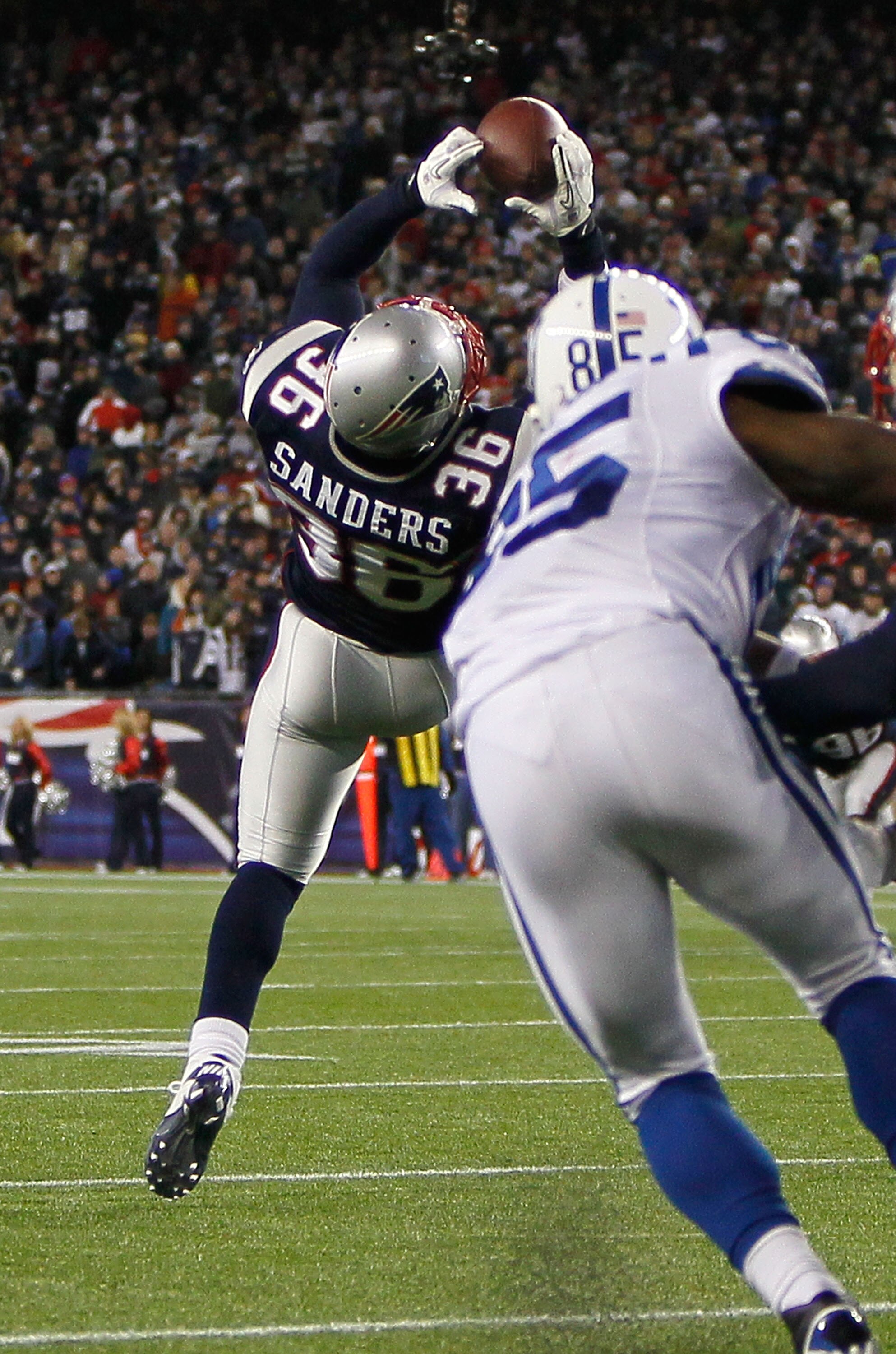 FOXBORO, MA - NOVEMBER 21: James Sanders #36 of the New England Patriots intercepts a pass in the fourth quarter as Pierre Garcon #85 of the Indianapolis Colts looks on at Gillette Stadium on November 21, 2010 in Foxboro, Massachusetts. The Patriots won 3