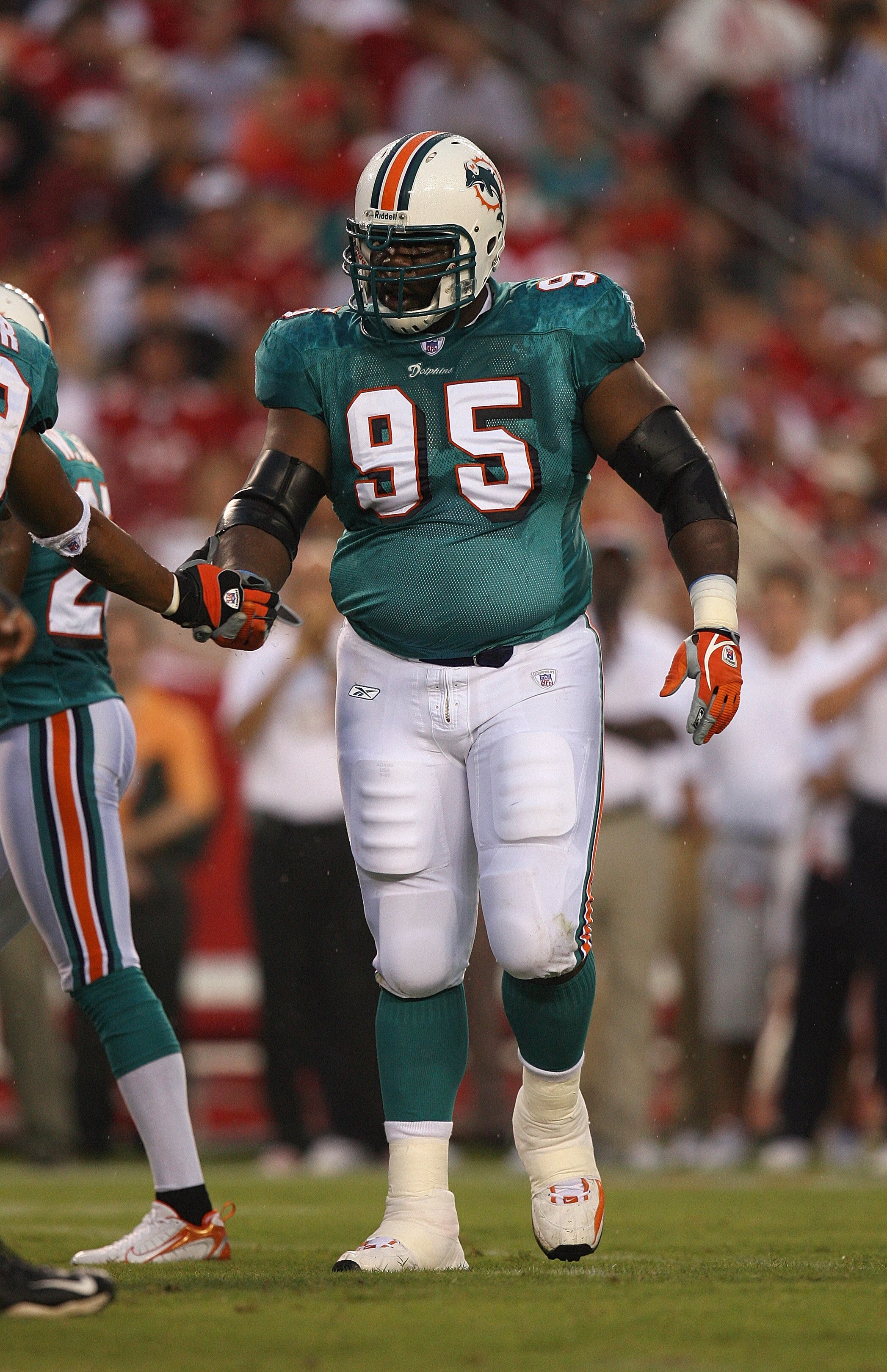 TAMPA, FL - AUGUST 19:  Dan Wilkinson #95 of the Miami Dolphins looks on during their NFL preseason game against the Tampa Bay Buccaneers at Raymond James Stadium on August 19, 2006 in Tampa, Florida. (Photo by Doug Benc/Getty Images)