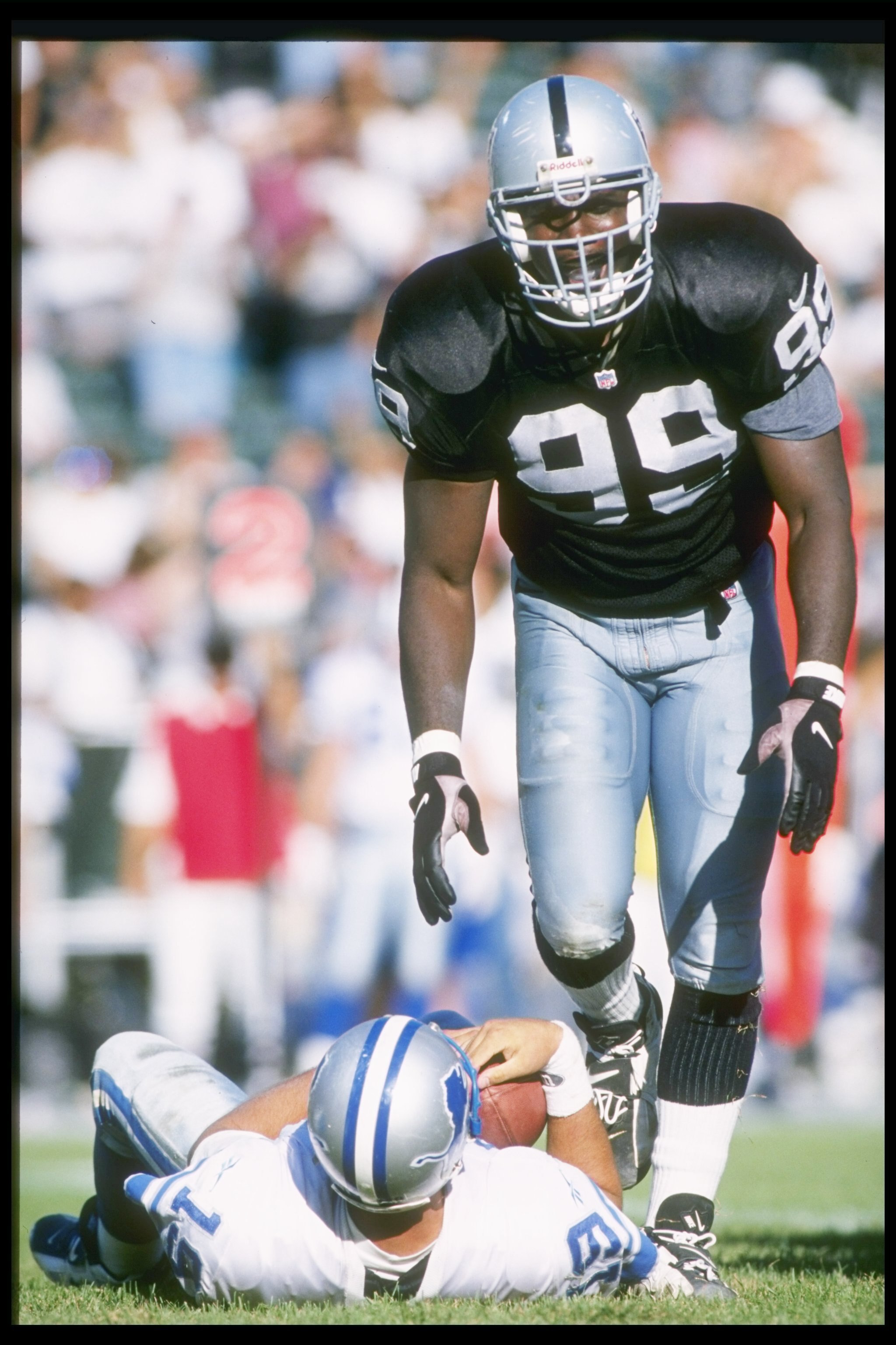 13 Oct 1996:  Defensive lineman Aundray Bruce of the Oakland Raiders looks on after hitting Detroit Lions quarterback Scott Mitchell during a game at the Oakland-Alameda County Coliseum in Oakland, California.  The Raiders won the game, 37-21. Mandatory C