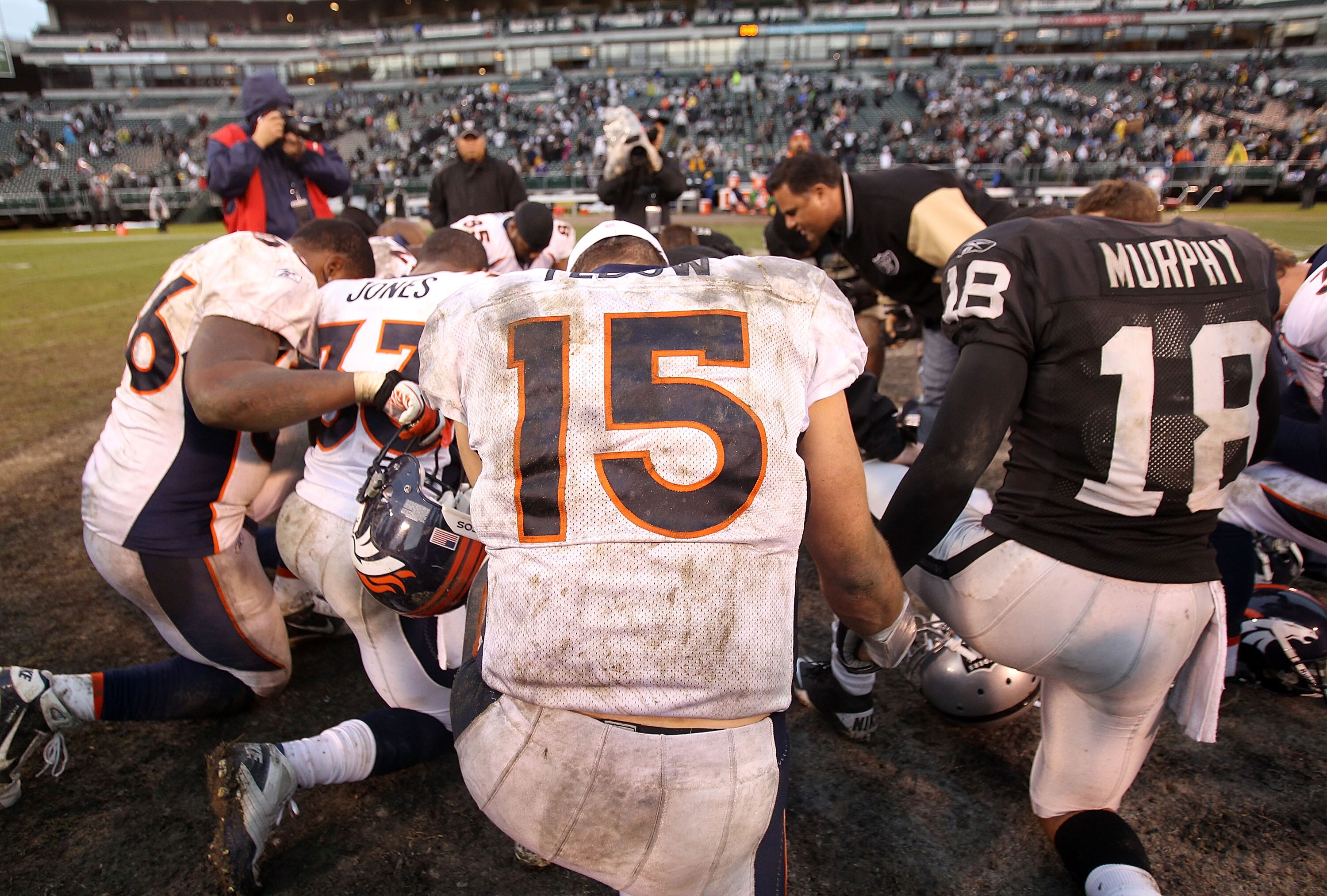 OAKLAND, CA - DECEMBER 19:  Tim Tebow #15 of the Denver Broncos prayers with a group of players after their game against the Oakland Raiders at Oakland-Alameda County Coliseum on December 19, 2010 in Oakland, California.  (Photo by Ezra Shaw/Getty Images)