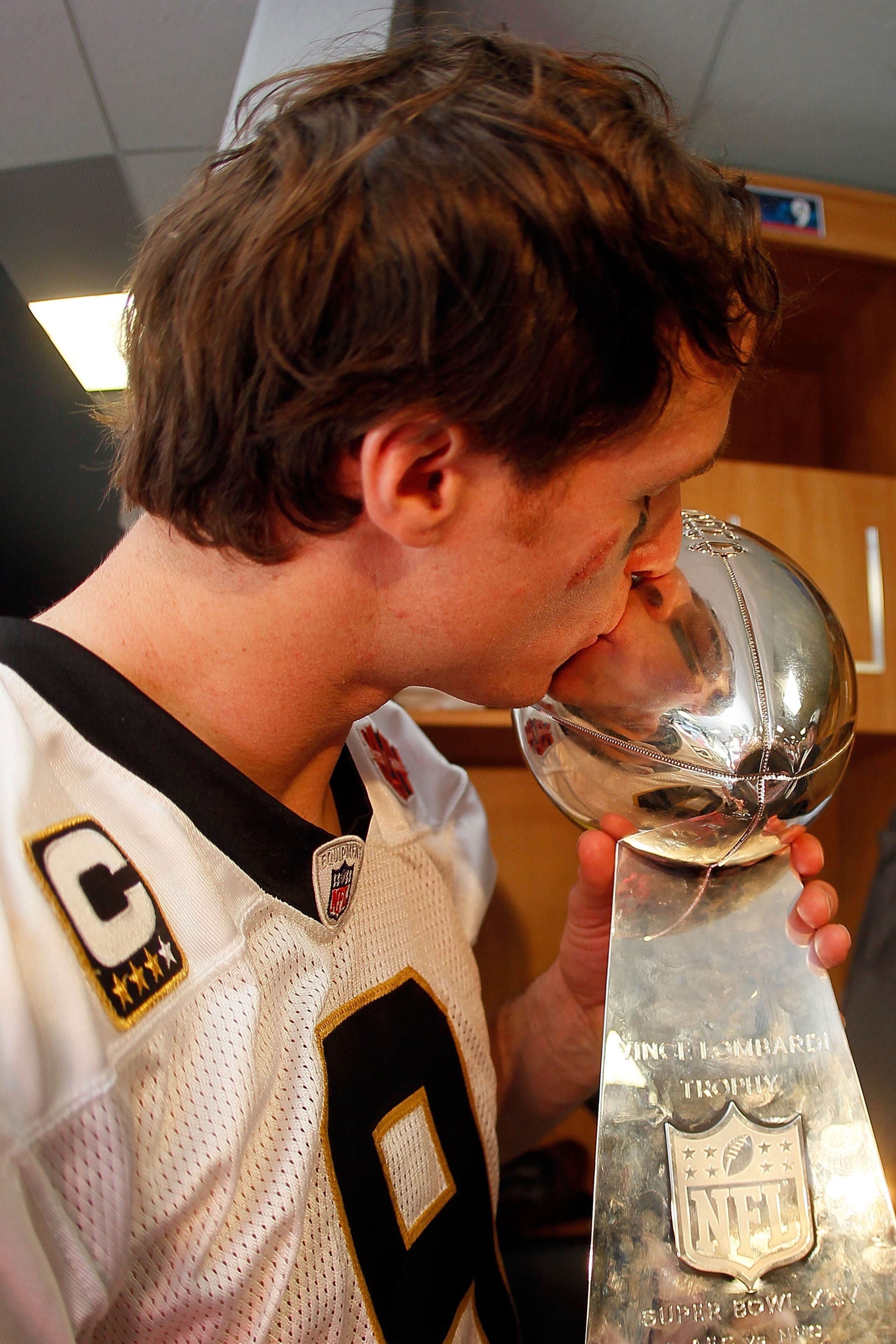 MIAMI GARDENS, FL - FEBRUARY 07:  Drew Brees #9 of the New Orleans Saints kisses the Vince Lombardi Trophy in the locker room after defeating the Indianapolis Colts during Super Bowl XLIV on February 7, 2010 at Sun Life Stadium in Miami Gardens, Florida.