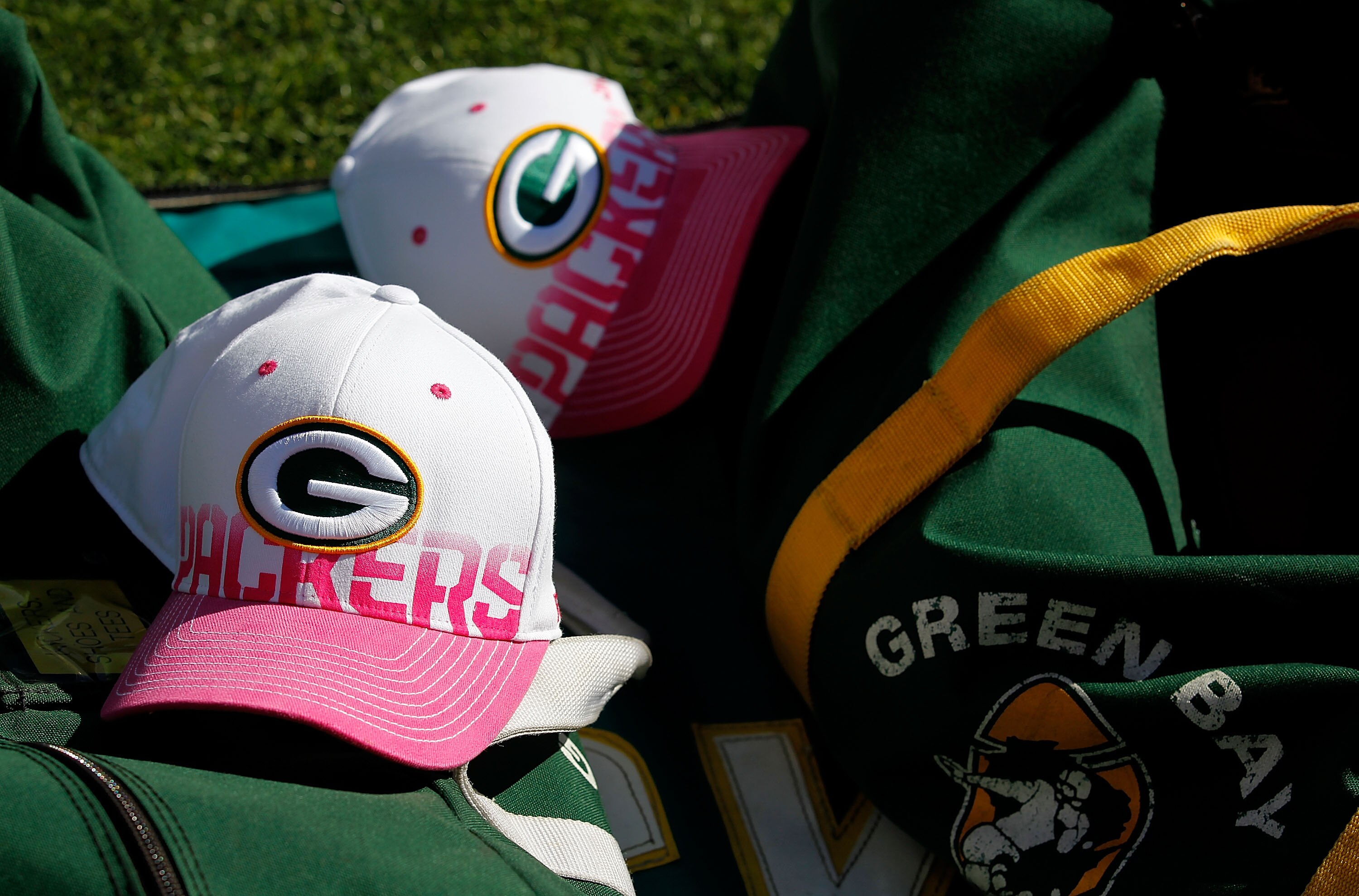GREEN BAY, WI - OCTOBER 03: Pink and white breast cancer awareness hats rest on a bag of footballs during a game bewteen the Green Bay Packers and the Detroit Lions at Lambeau Field on October 3, 2010 in Green Bay, Wisconsin. The Packers defeated the Bear