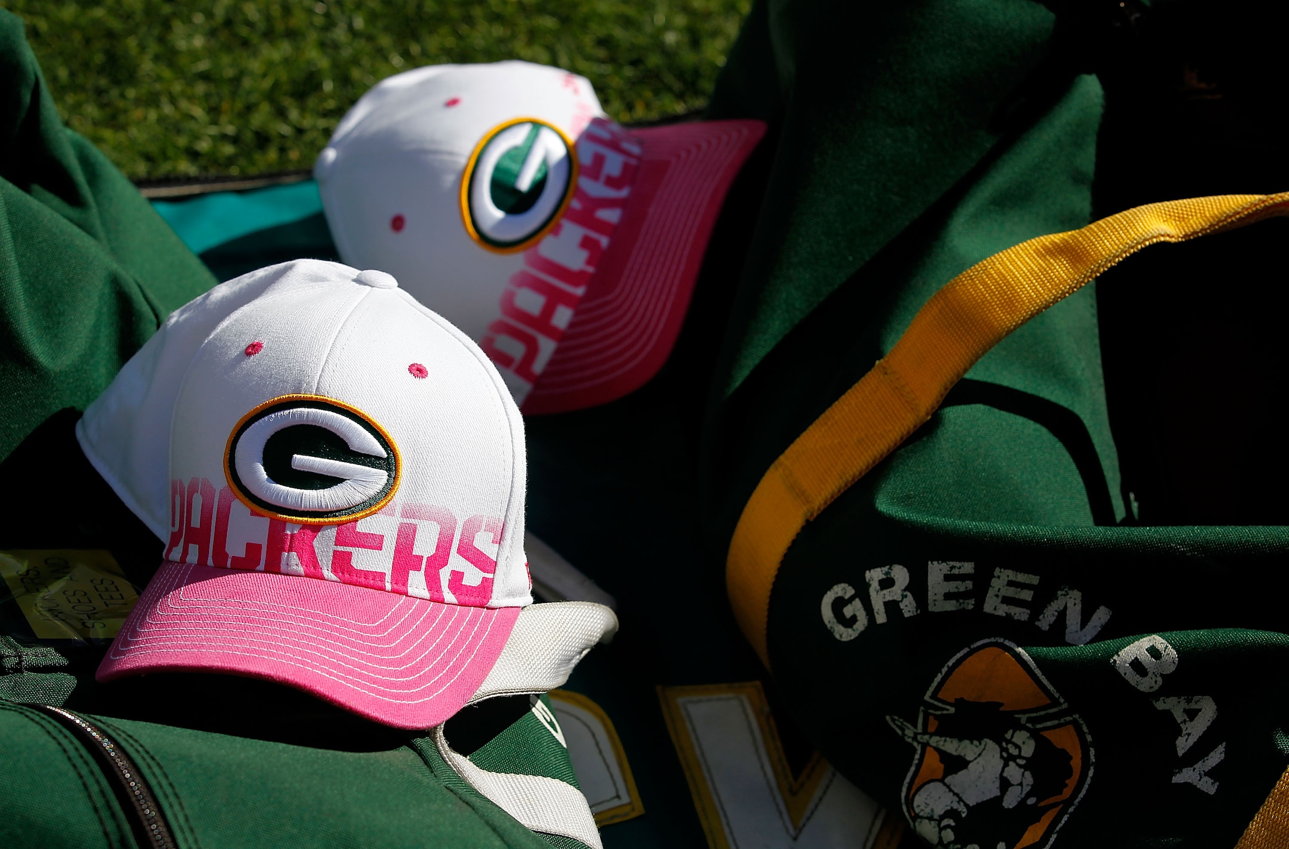 GREEN BAY, WI - OCTOBER 03: Pink and white breast cancer awareness hats rest on a bag of footballs during a game bewteen the Green Bay Packers and the Detroit Lions at Lambeau Field on October 3, 2010 in Green Bay, Wisconsin. The Packers defeated the Bear