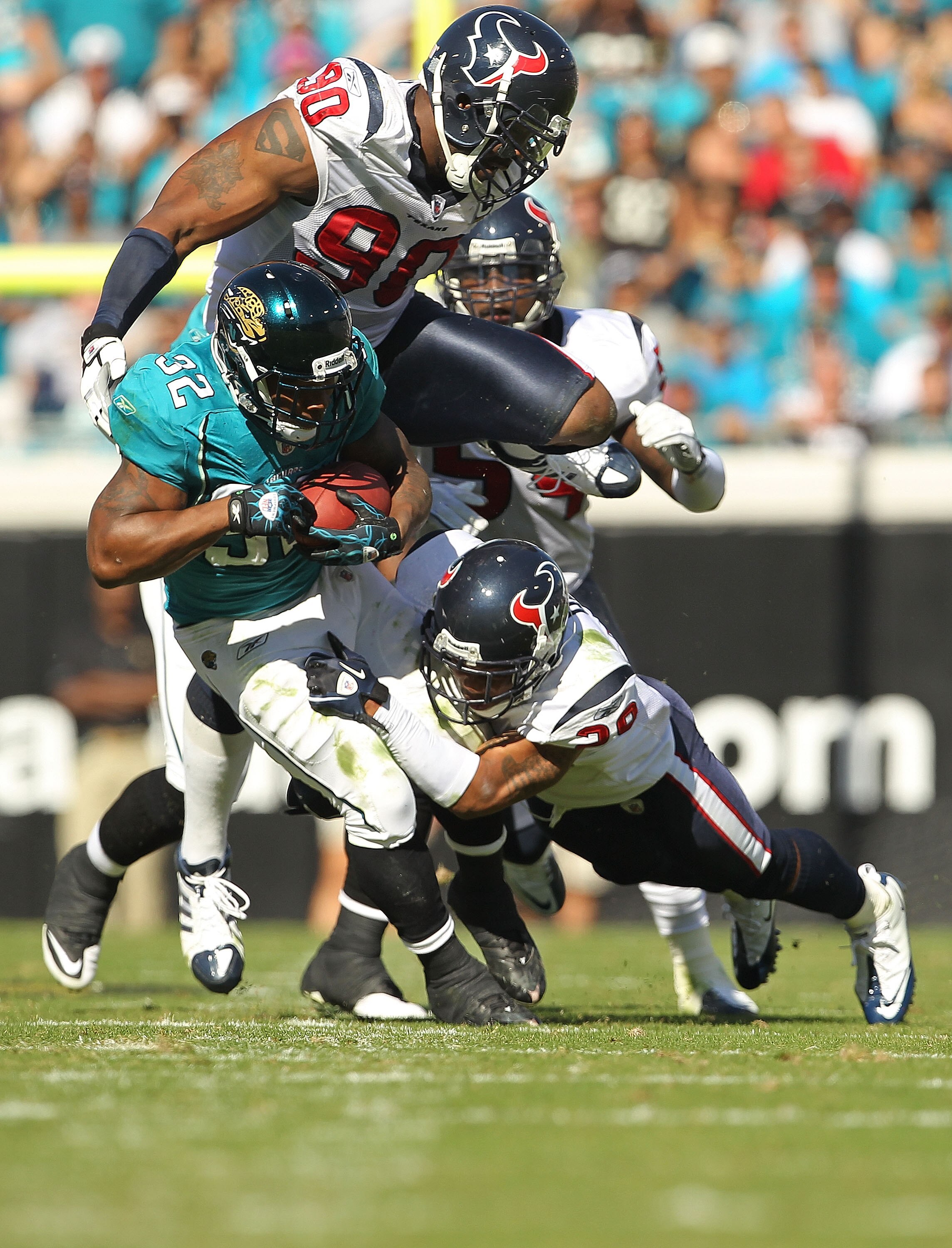 JACKSONVILLE, FL - NOVEMBER 14:  Maurice Jones-Drew #32 of the Jacksonville Jaguars is tackled by Glover Quin #29 during a game against the Houston Texans at EverBank Field on November 14, 2010 in Jacksonville, Florida.  (Photo by Mike Ehrmann/Getty Image