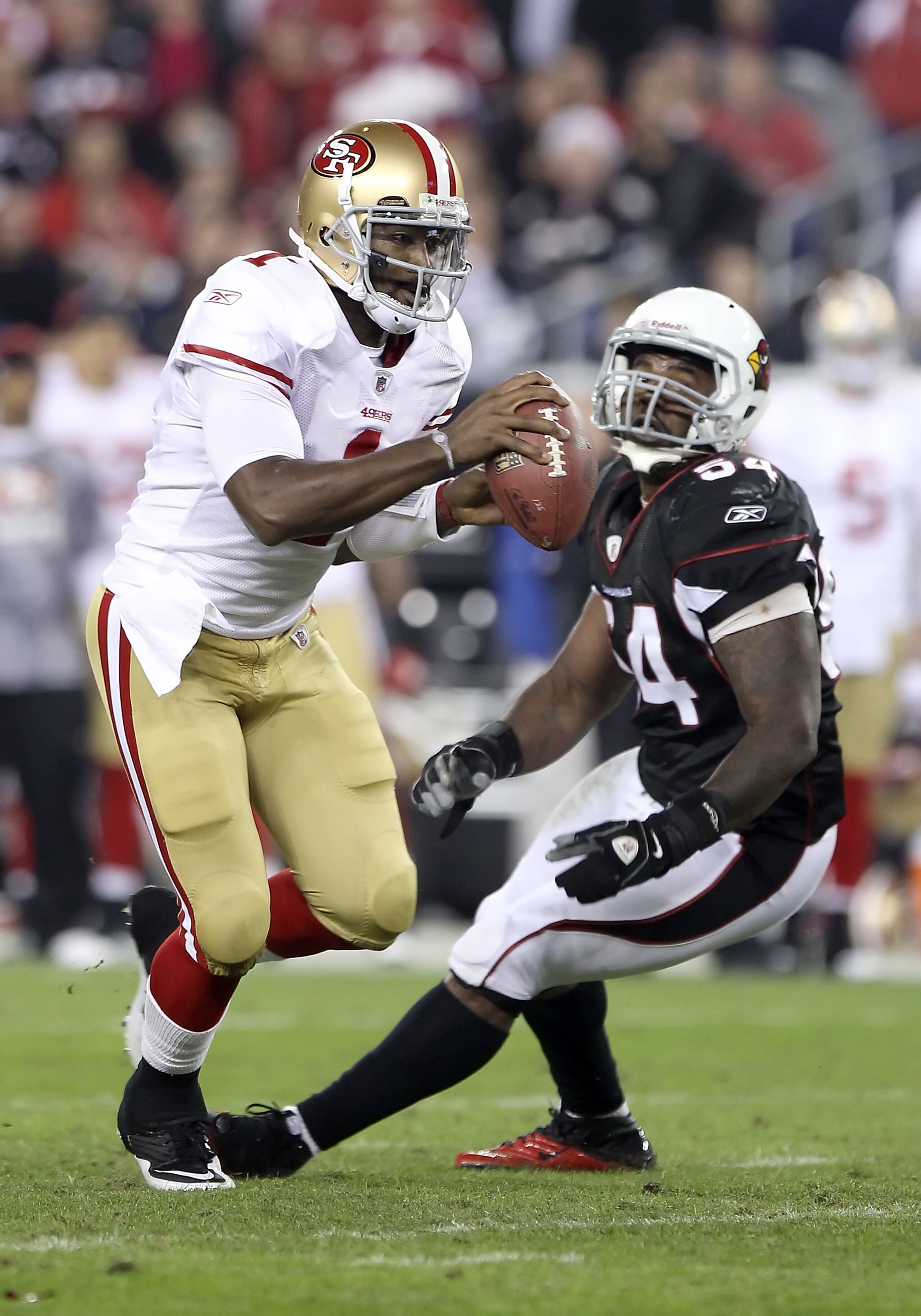 GLENDALE, AZ - NOVEMBER 29: Quarterback Troy Smith #1 of the San Francisco 49ers scrambles with the football during the NFL game against the Arizona Cardinals at the University of Phoenix Stadium on November 29, 2010 in Glendale, Arizona. The 49ers defea GLENDALE, AZ - NOVEMBER 29: Quarterback Troy Smith #1 of the San Francisco 49ers scrambles with the football during the NFL game against the Arizona Cardinals at the University of Phoenix Stadium on November 29, 2010 in Glendale, Arizona. The 49ers defea