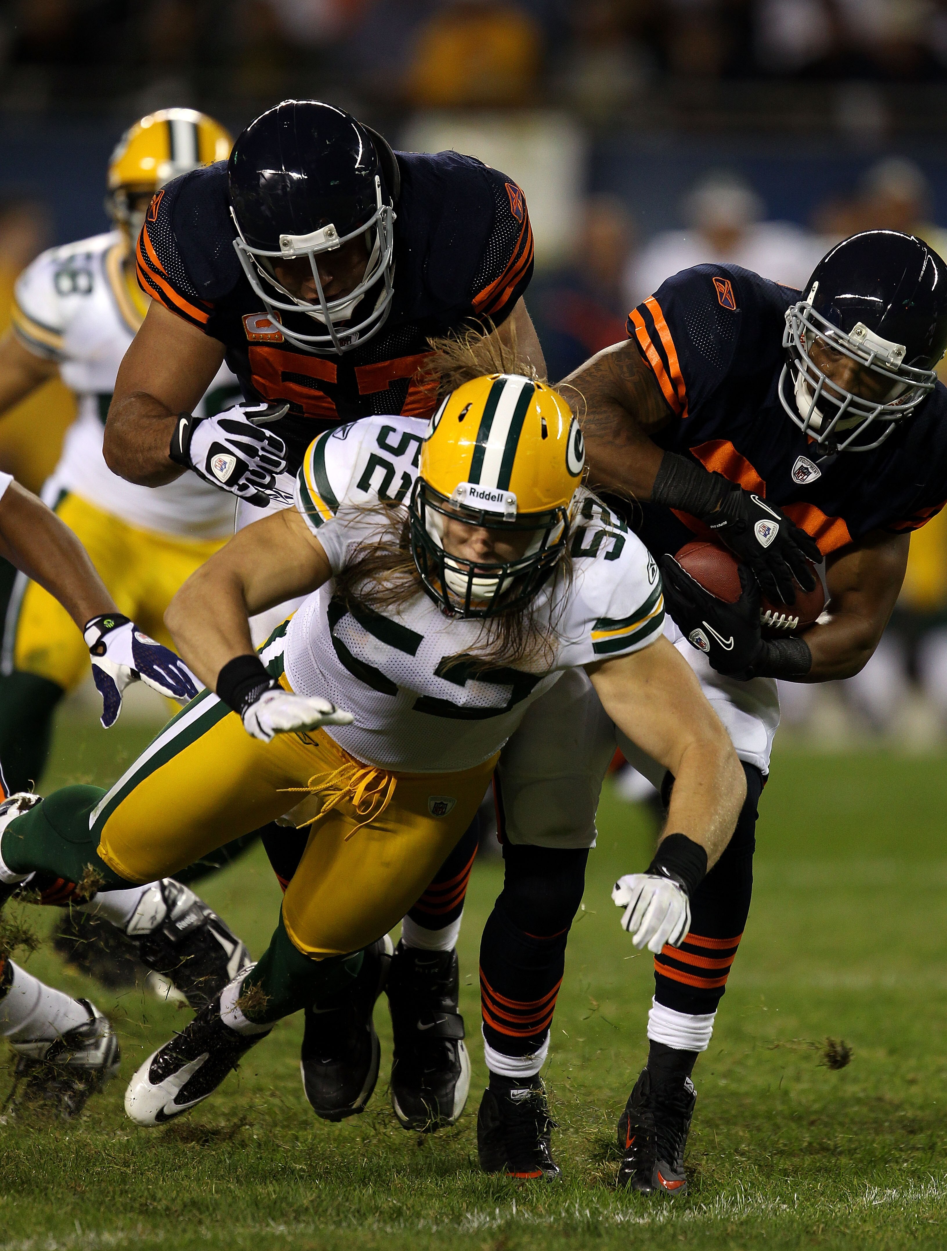 CHICAGO - SEPTEMBER 27:  Matt Forte #22 (R) of the Chicago Bears runs the ball behind the block of center Olin Kreutz #57 (L) against Clay Matthews #52 of the Green Bay Packers at Soldier Field on September 27, 2010 in Chicago, Illinois. The Bears won 20-