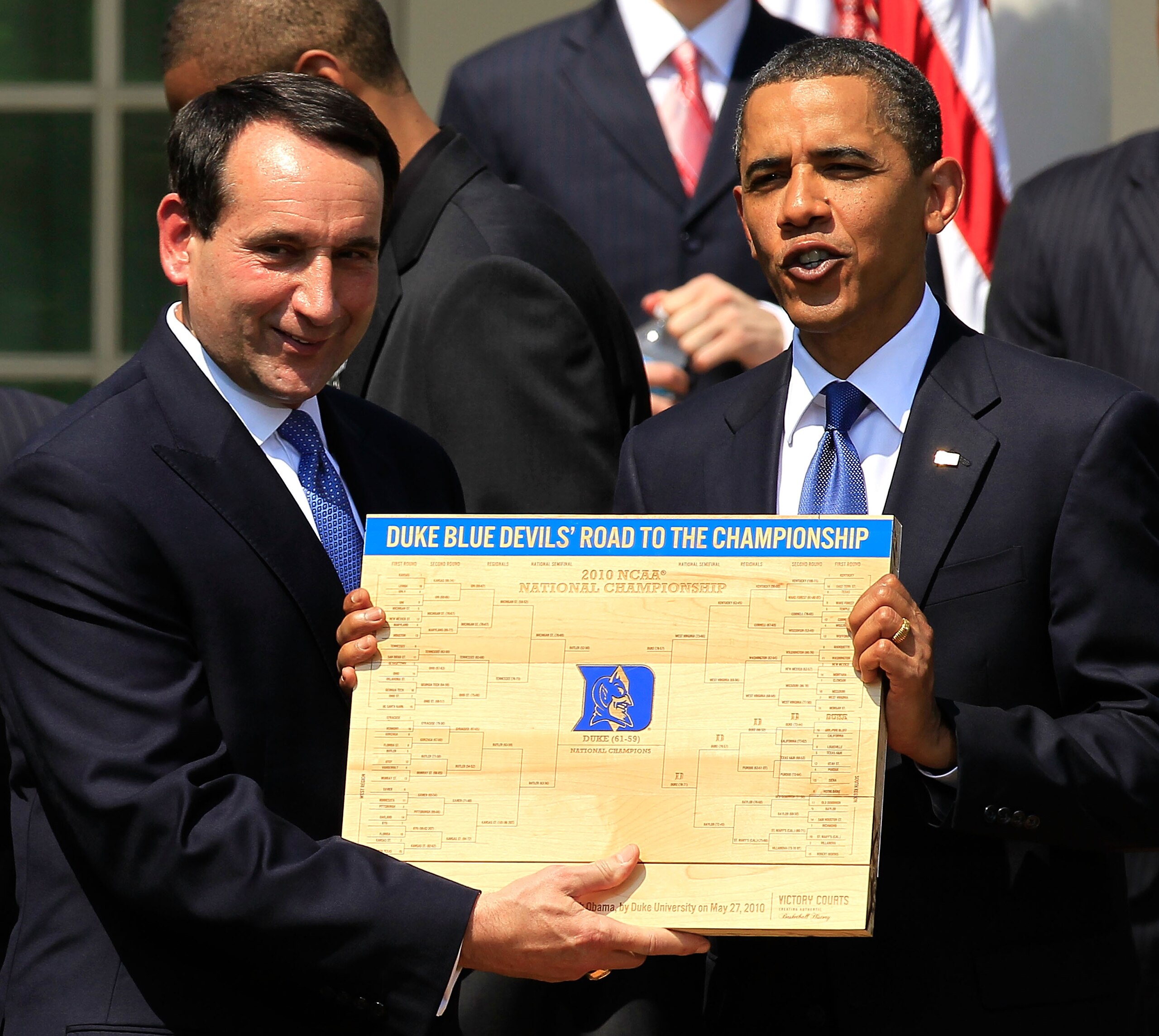 WASHINGTON - MAY 27:  U.S. President Barack Obama (R) is presented with a plaque of a bracket by coach Mike Krzyzewski (L) of the Duke Blue Devils during a Rose Garden event May 27, 2010 at the White House in Washington, DC. Obama hosted the NCAA men bask