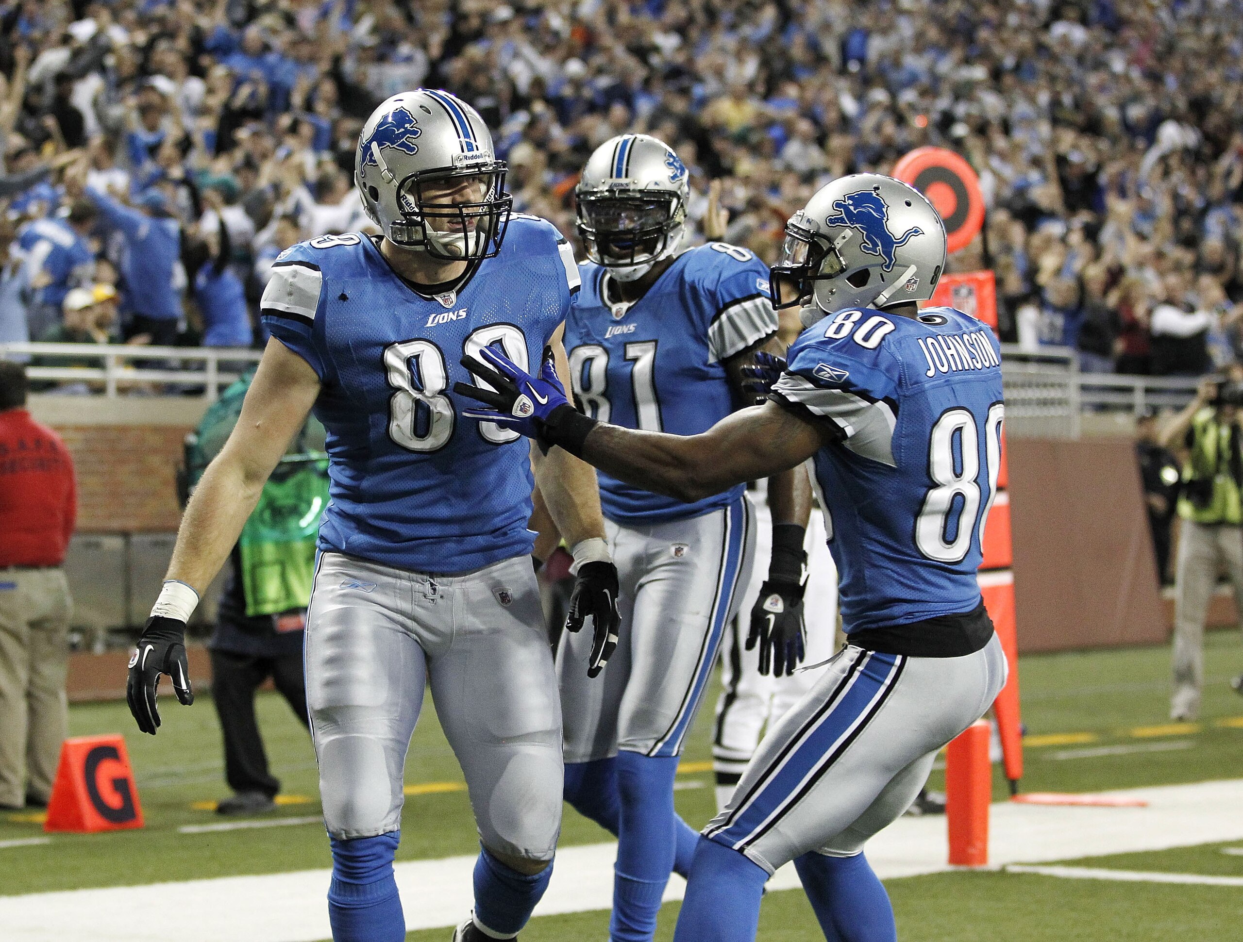 DETROIT, MI - DECEMBER 12:  Will Heller #89 of the Detroit Lions celebrates a for a fourth quarter touchdown with Bryant Johnson #80 and Calvin Johnson #81 while playing the Green Bay Packers on December 12, 2010 at Ford Field in Detroit, Michigan. Detroi