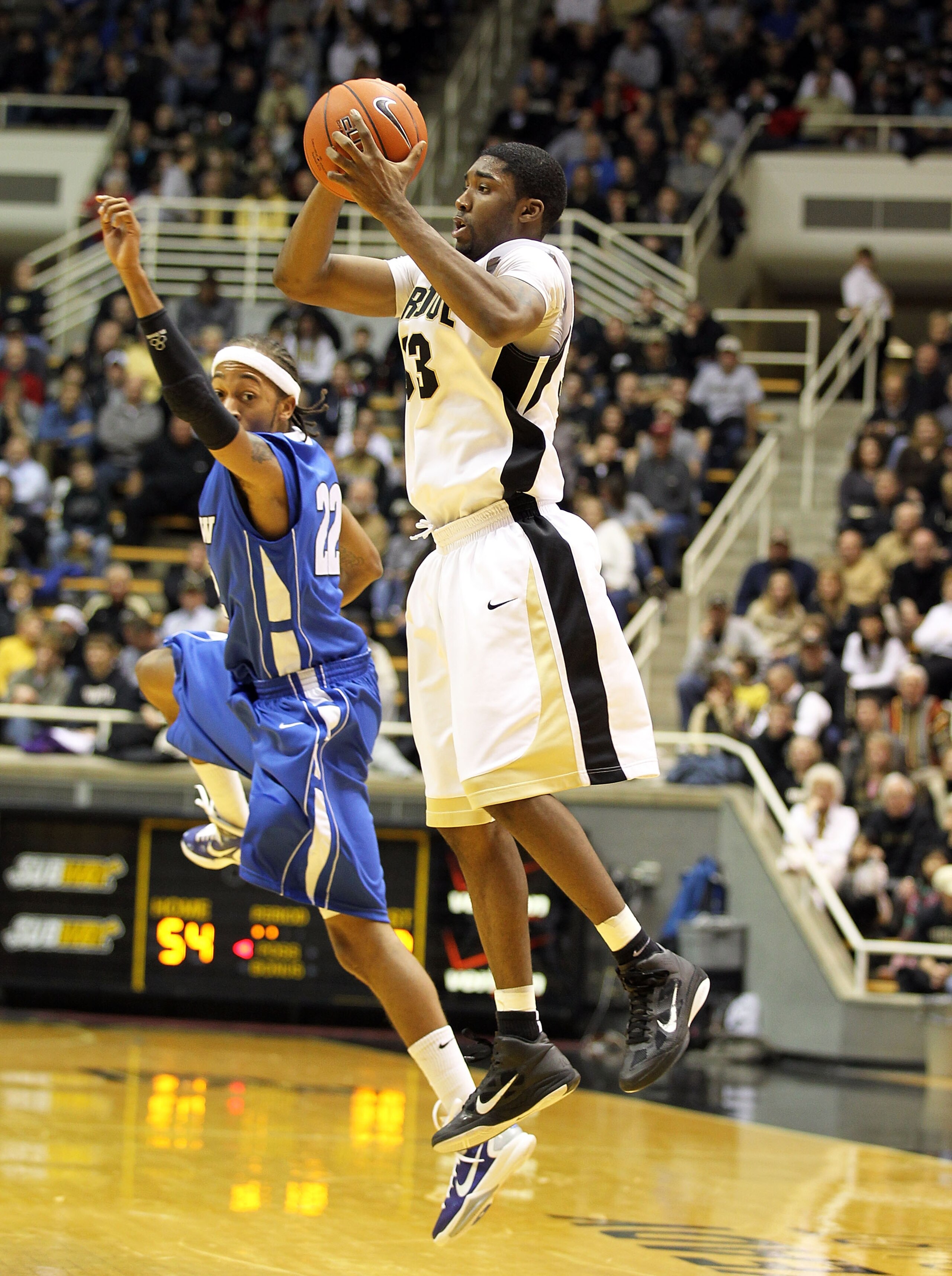 WEST LAFAYETTE, IN - DECEMBER 21:  E ' Twaun Moore #33 of the Purdue Boilermakers grabs a loose ball while defended by Jeremy Mixon #22 of the IPFW Mastodons during the game at Mackey Arena on December 21, 2010 in West Lafayette, Indiana.  (Photo by Andy