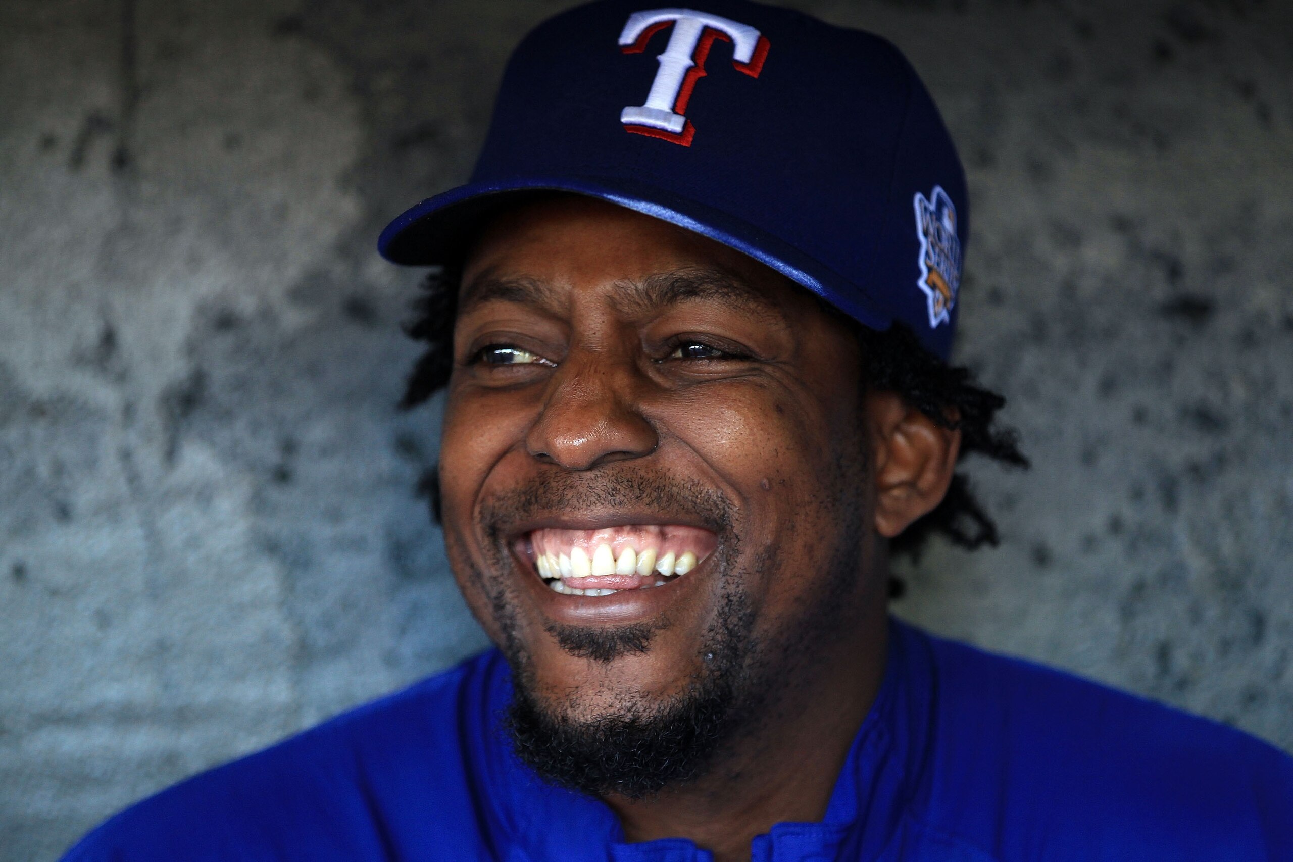 SAN FRANCISCO - OCTOBER 26:  Vladimir Guerrero #27 of the Texas Rangers smiles while sittting in the dugout during a workout session at AT&T Park on October 26, 2010 in San Francisco, California. The Texas Rangers will face off against the San Francisco G