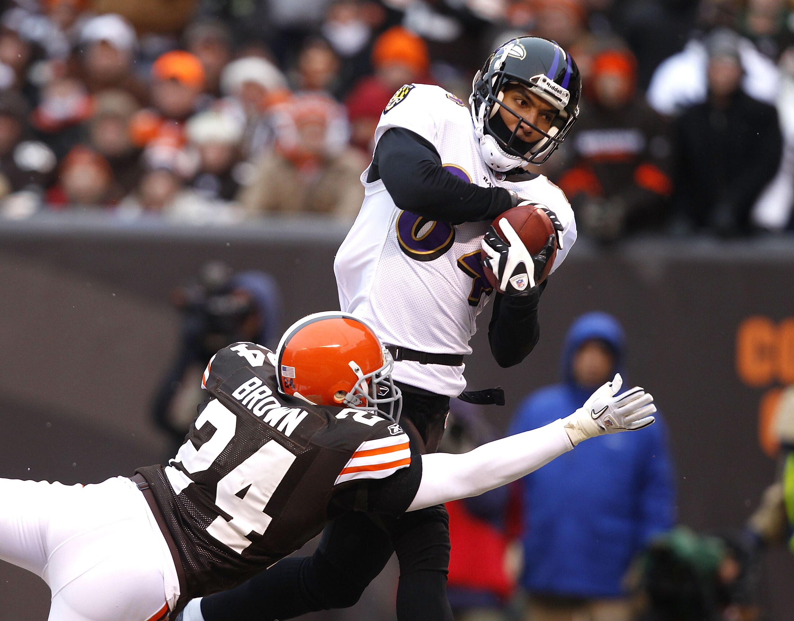 CLEVELAND - DECEMBER 26:  Wide receiver T.J. Houshmandzadeh, #84 of the Baltimore Ravens catches a touchdown pass over defensive back Sheldon Brown, #24 of the Cleveland Browns at Cleveland Browns Stadium on December 26, 2010 in Cleveland, Ohio.  (Photo b