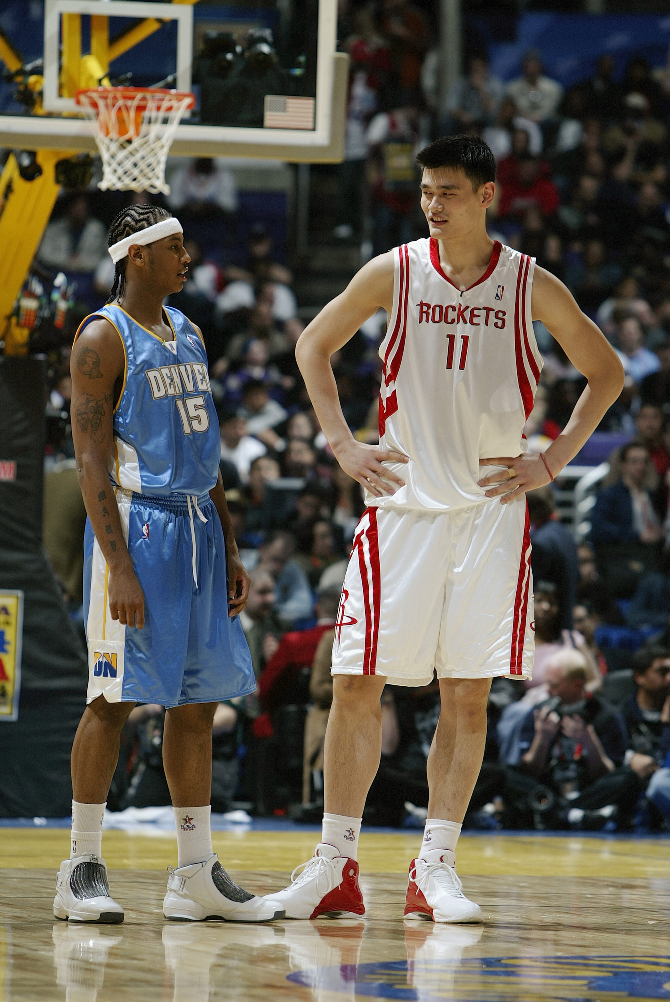 LOS ANGELES - FEBRUARY 13:  Carmelo Anthony #15 of the Rookie Team stands next  Yao Ming #11 of the Sophomore Team during the Got Milk? Rookie Challenge, part of the 53rd NBA All-Star weekend, at Staples Center on February 13, 2004 in Los Angeles, Califor