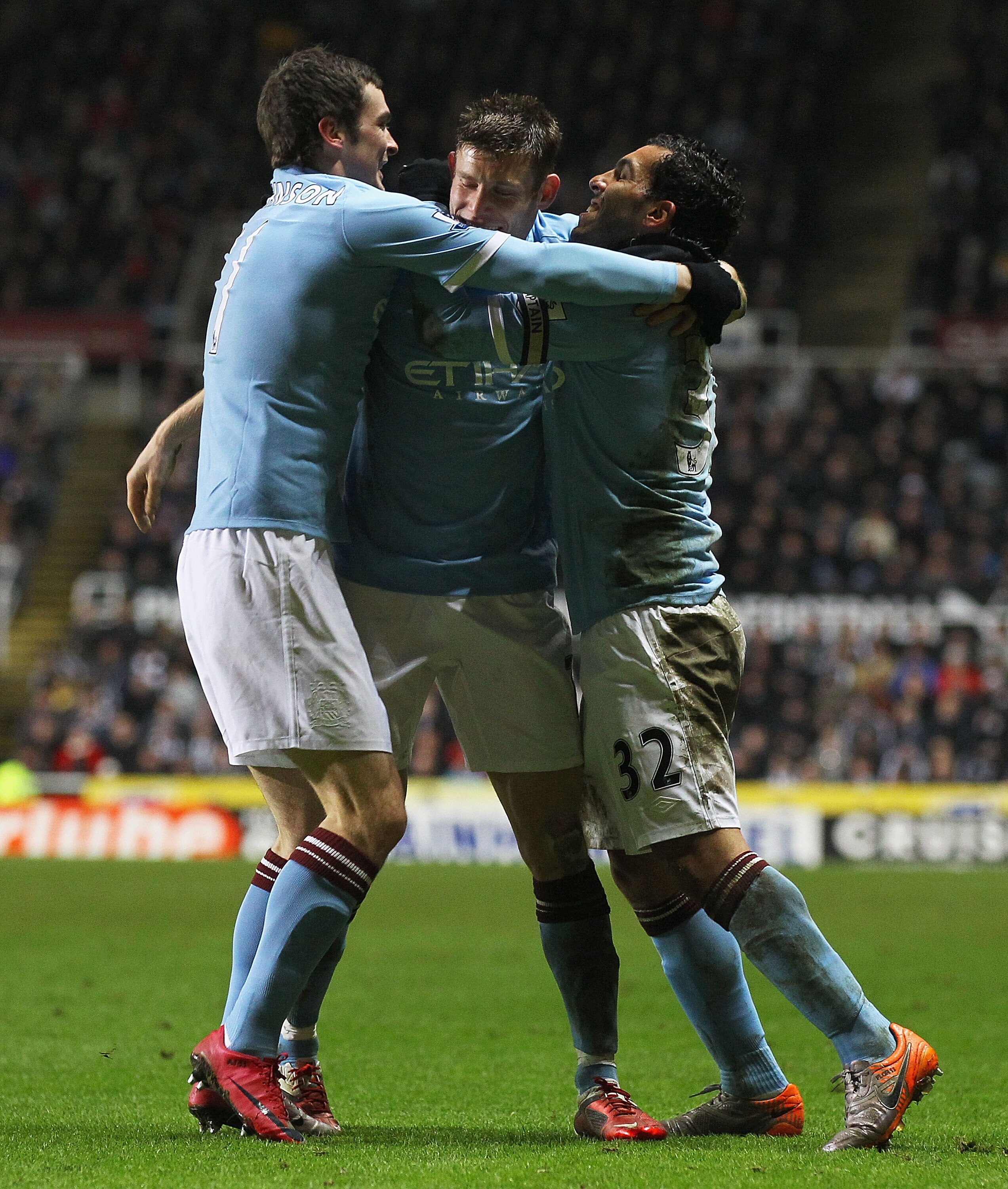 NEWCASTLE UPON TYNE, ENGLAND - DECEMBER 26:  Carlos Tevez of Manchester City celebrates his second goal with James Milner and Adam Johnson during the Barclays Premier League match between Newcastle United and Manchester City at St James' Park on December 