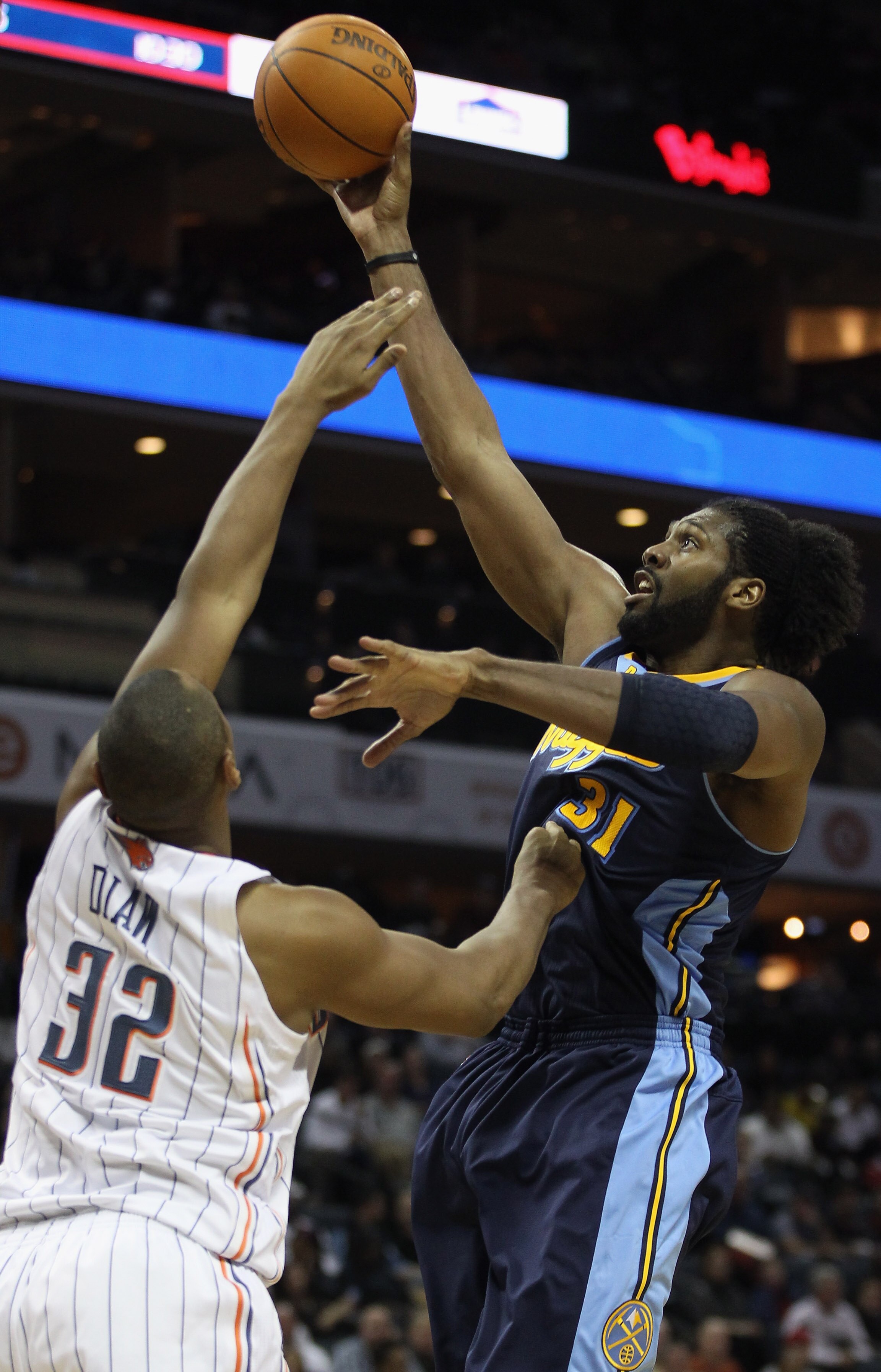 CHARLOTTE, NC - DECEMBER 07:  Nene #31 of the Denver Nuggets shoots the ball over Boris Diaw #32 of the Charlotte Bobcats during their game at Time Warner Cable Arena on December 7, 2010 in Charlotte, North Carolina.  NOTE TO USER: User expressly acknowle