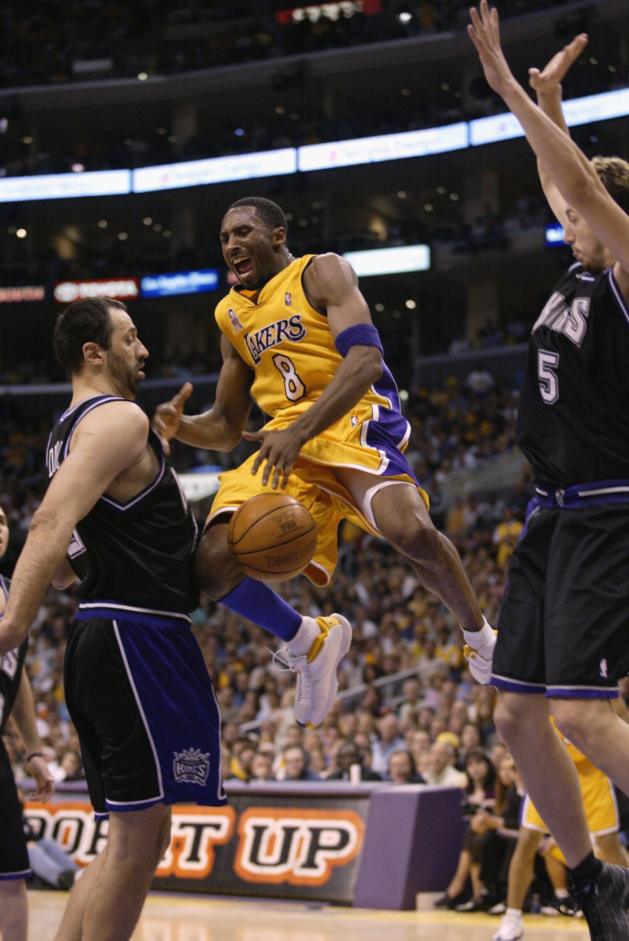 LOS ANGELES - MAY 26: Kobe Bryant #8 of the Los Angeles Lakers loses the ball under pressure from Vlade Divac #21 of the Sacramento Kings in Game four of the Western Conference Finals during the 2002 NBA Playoffs at Staples Center in Los Angeles, Californ