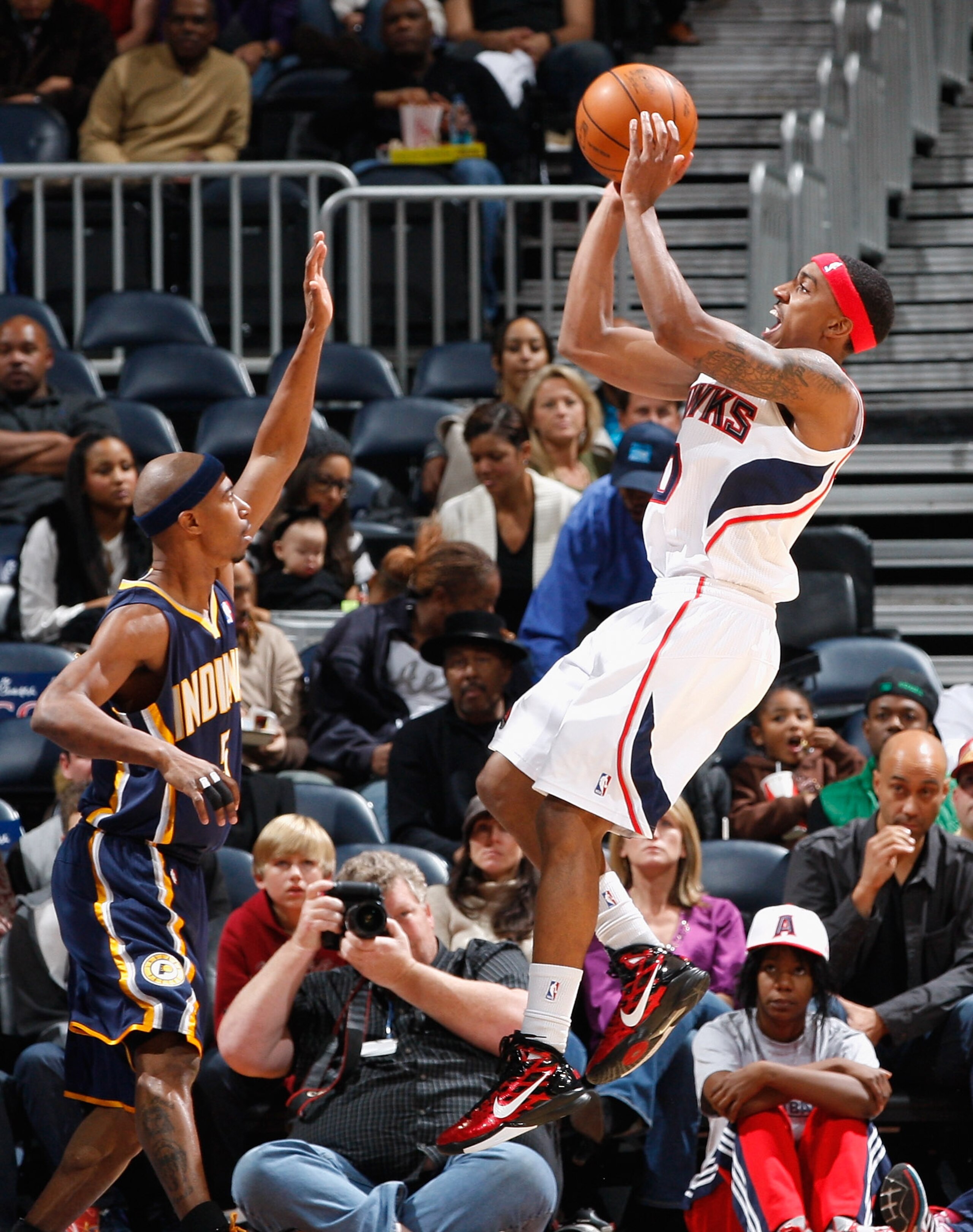 ATLANTA, GA - DECEMBER 11: Jeff Teague #0 of the Atlanta Hawks shoots over T.J. Ford #5 of the Indiana Pacers at Philips Arena on December 11, 2010 in Atlanta, Georgia. NOTE TO USER: User expressly acknowledges and agrees that, by downloading and/or us ATLANTA, GA - DECEMBER 11: Jeff Teague #0 of the Atlanta Hawks shoots over T.J. Ford #5 of the Indiana Pacers at Philips Arena on December 11, 2010 in Atlanta, Georgia. NOTE TO USER: User expressly acknowledges and agrees that, by downloading and/or us