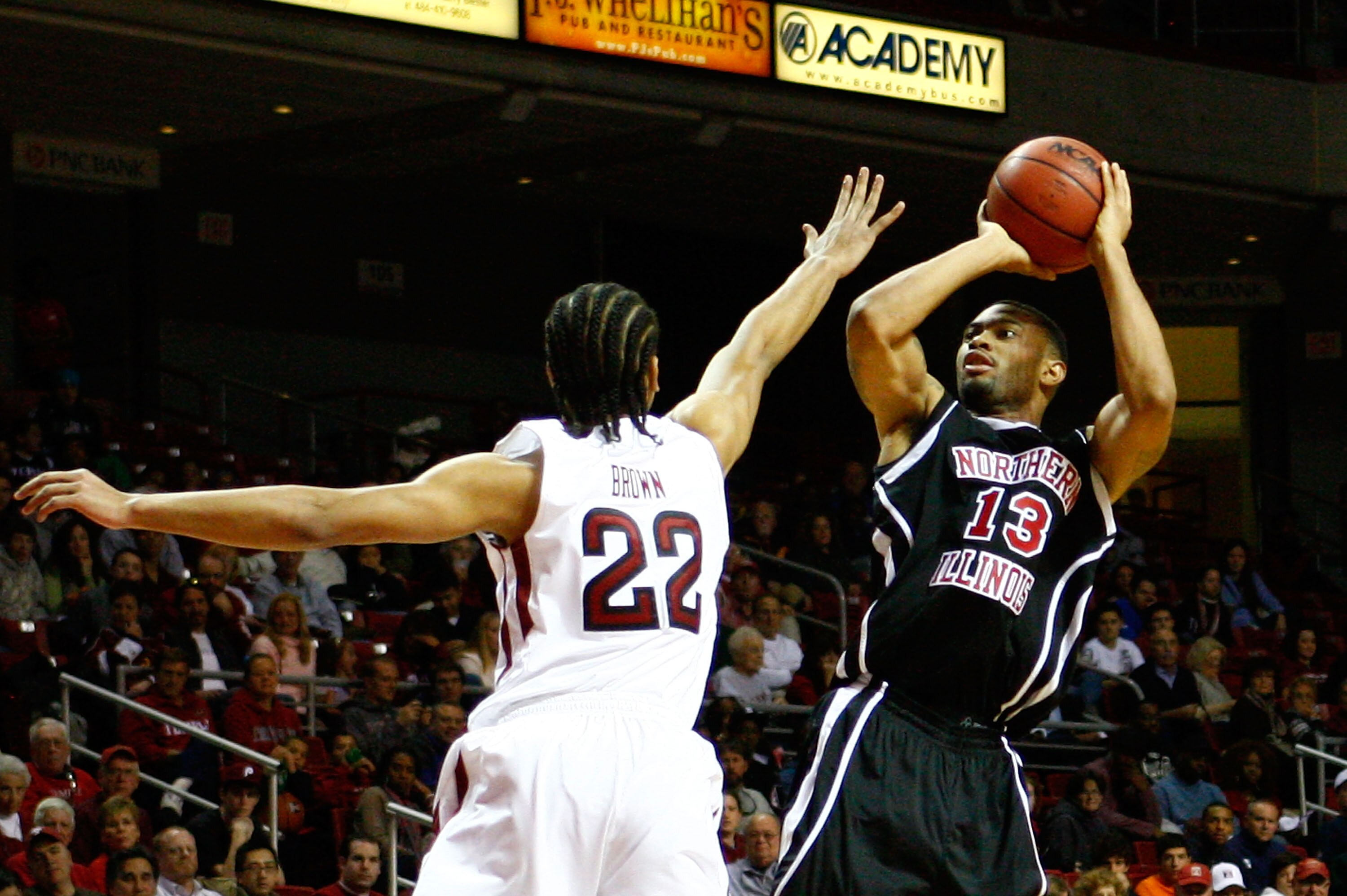 PHILADELPHIA, PA - DECEMBER 18:  Xavier Silas #13 of the Northern Illinois Huskies attempts a shot against Aaron Brown #22 of the Temple Owls at the Liacouras Center on December 18, 2010 in Philadelphia, Pennsylvania.  (Photo by Chris Chambers/Getty Image