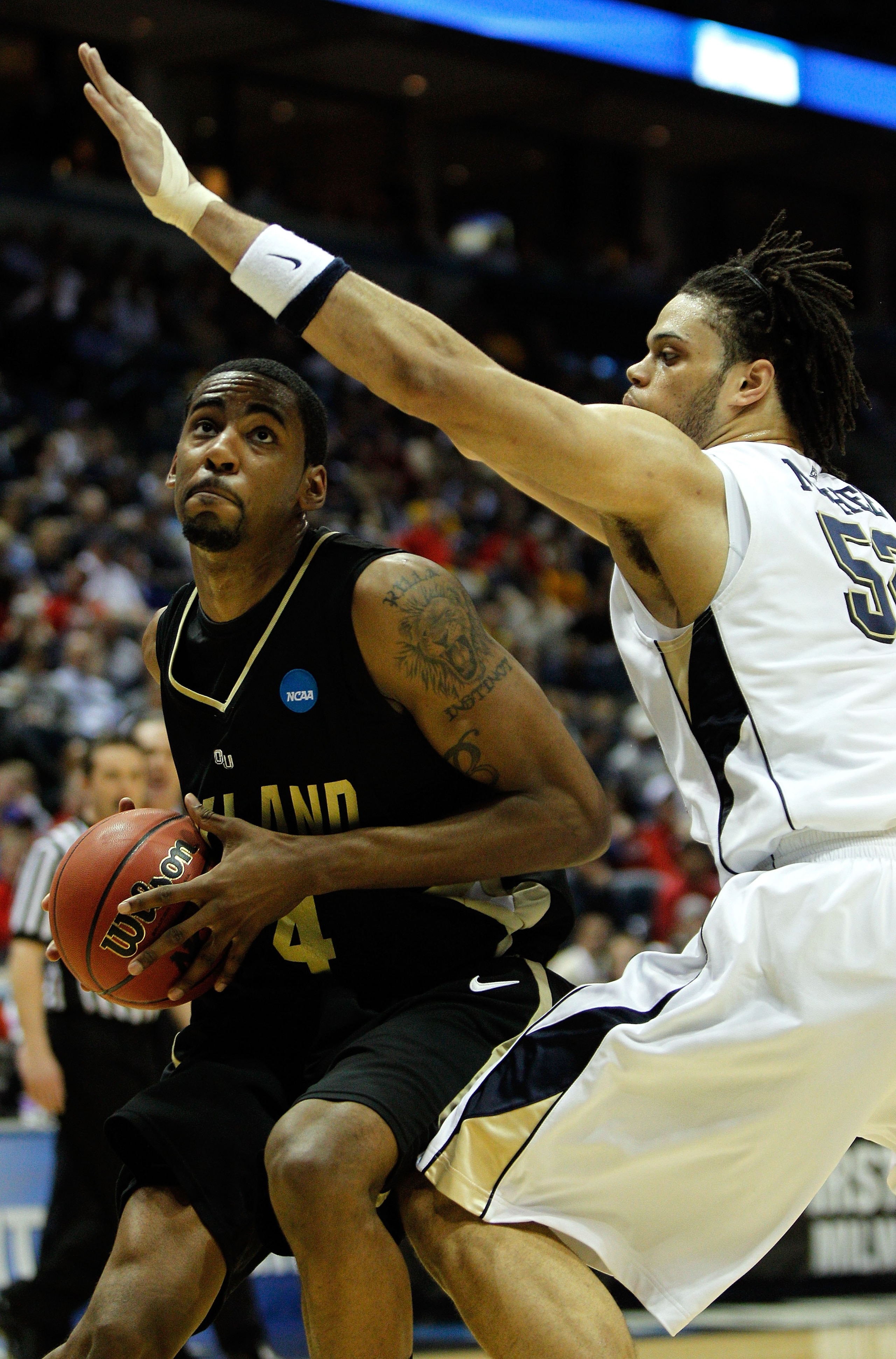 MILWAUKEE - MARCH 19:  Keith Benson #34 of the Oakland Golden Grizzlies looks to shoot over Gary McGhee #52 of the of the Pittsburgh Panthers in the first half during the first round of the 2010 NCAA men's basketball tournament at the Bradley Center on Ma