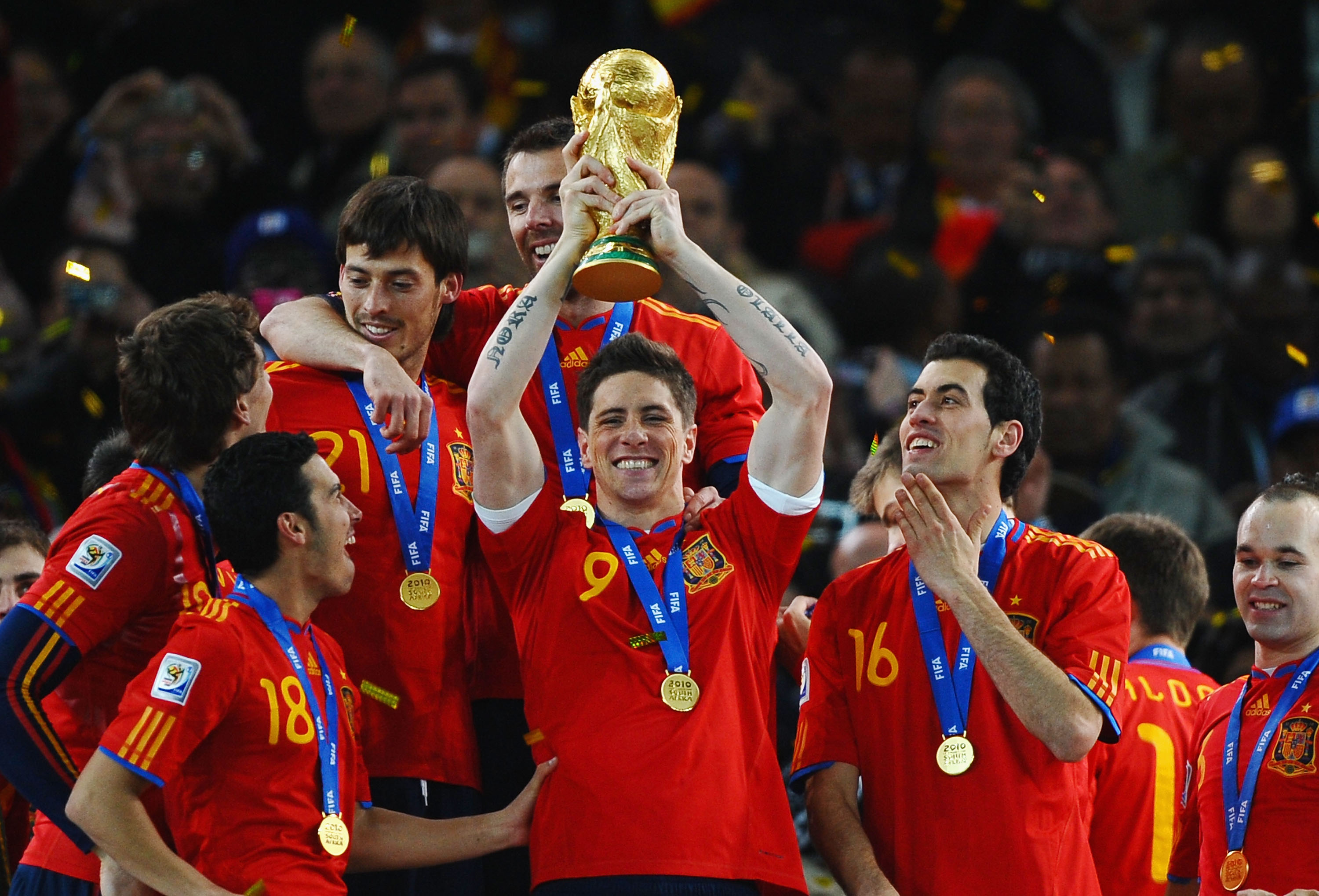 JOHANNESBURG, SOUTH AFRICA - JULY 11:  Fernando Torres of Spain lifts the World Cup trophy as the Spain team celebrate victory following the 2010 FIFA World Cup South Africa Final match between Netherlands and Spain at Soccer City Stadium on July 11, 2010