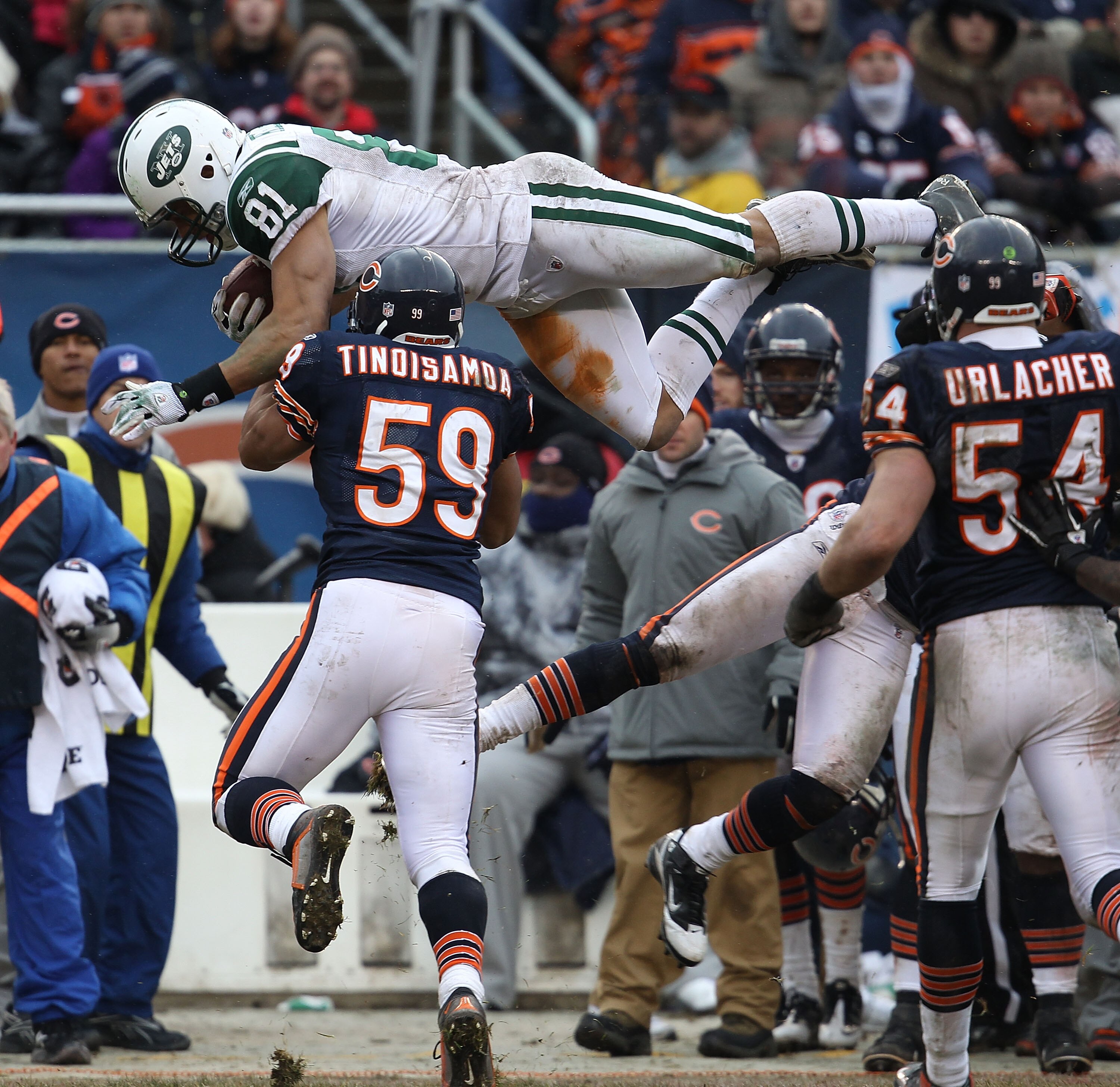 CHICAGO, IL - DECEMBER 26: Dustin Keller #81 of the New York Jets goes airbourne over Pisa Tinoisamoa #59 of the Chicago Bears for a first down at Soldier Field on December 26, 2010 in Chicago, Illinois. The Bears defeated the Jets 38-34. (Photo by Jonath