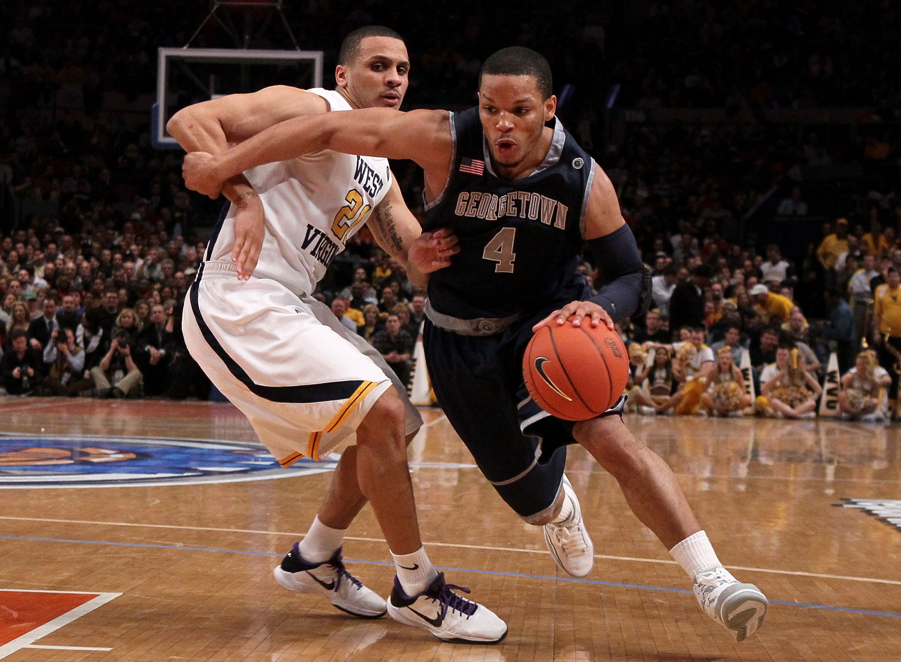 NEW YORK - MARCH 13:  Chris Wright #4 of the Georgetown Hoyas handles the ball against Joe Mazzulla #21 of the West Virginia Mountaineers during the championship of the 2010 NCAA Big East Tournament at Madison Square Garden on March 13, 2010 in New York C