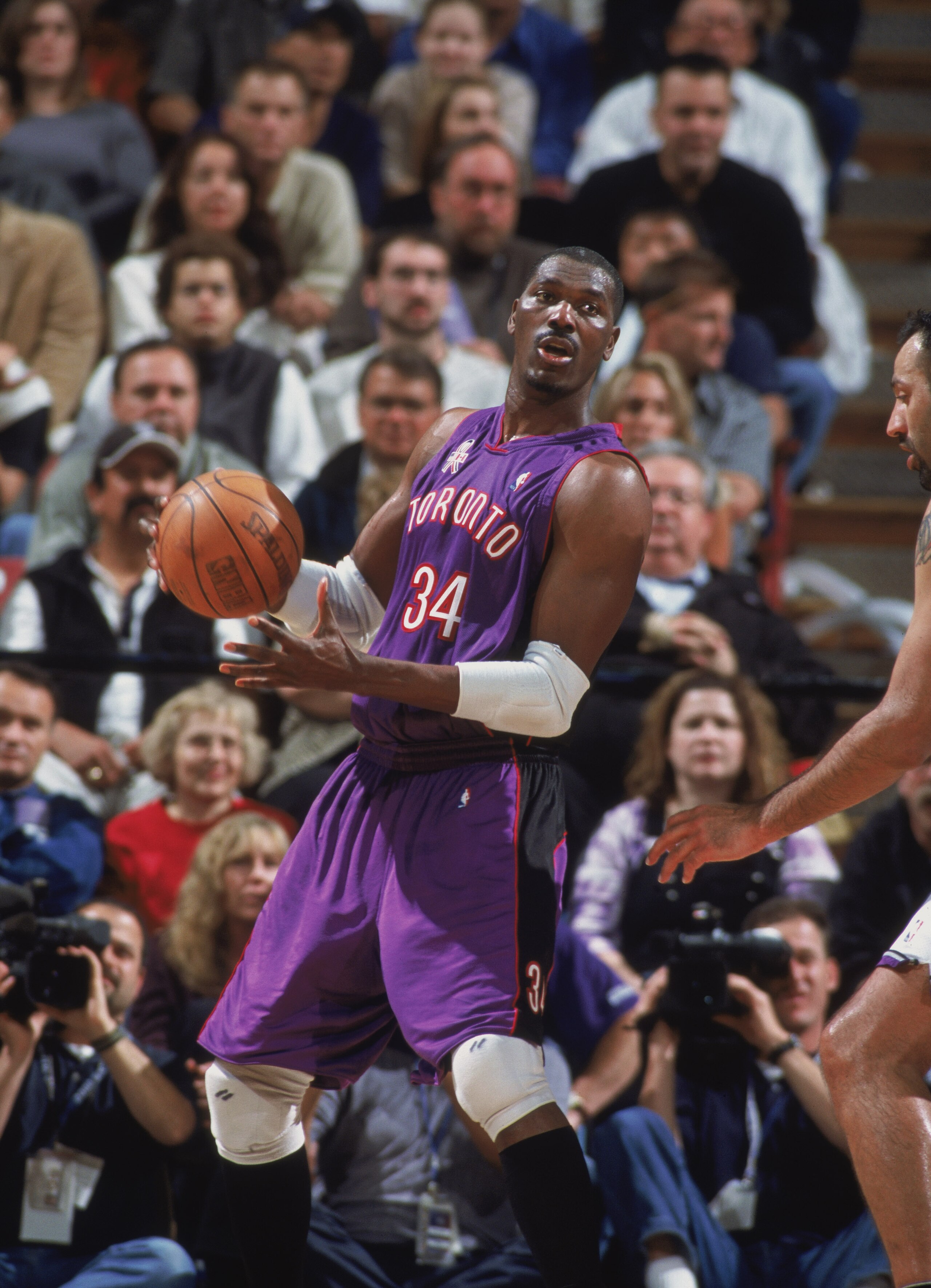 14 Nov 2001:  Center Hakeem Olajuwon #34 of the Toronto Raptors looks to play the ball against the Sacramento Kings during the NBA game at Arco Arena in Sacramento, California. The Kings defeated the Raptors 95-86. NOTE TO USER:  User expressly acknowledg