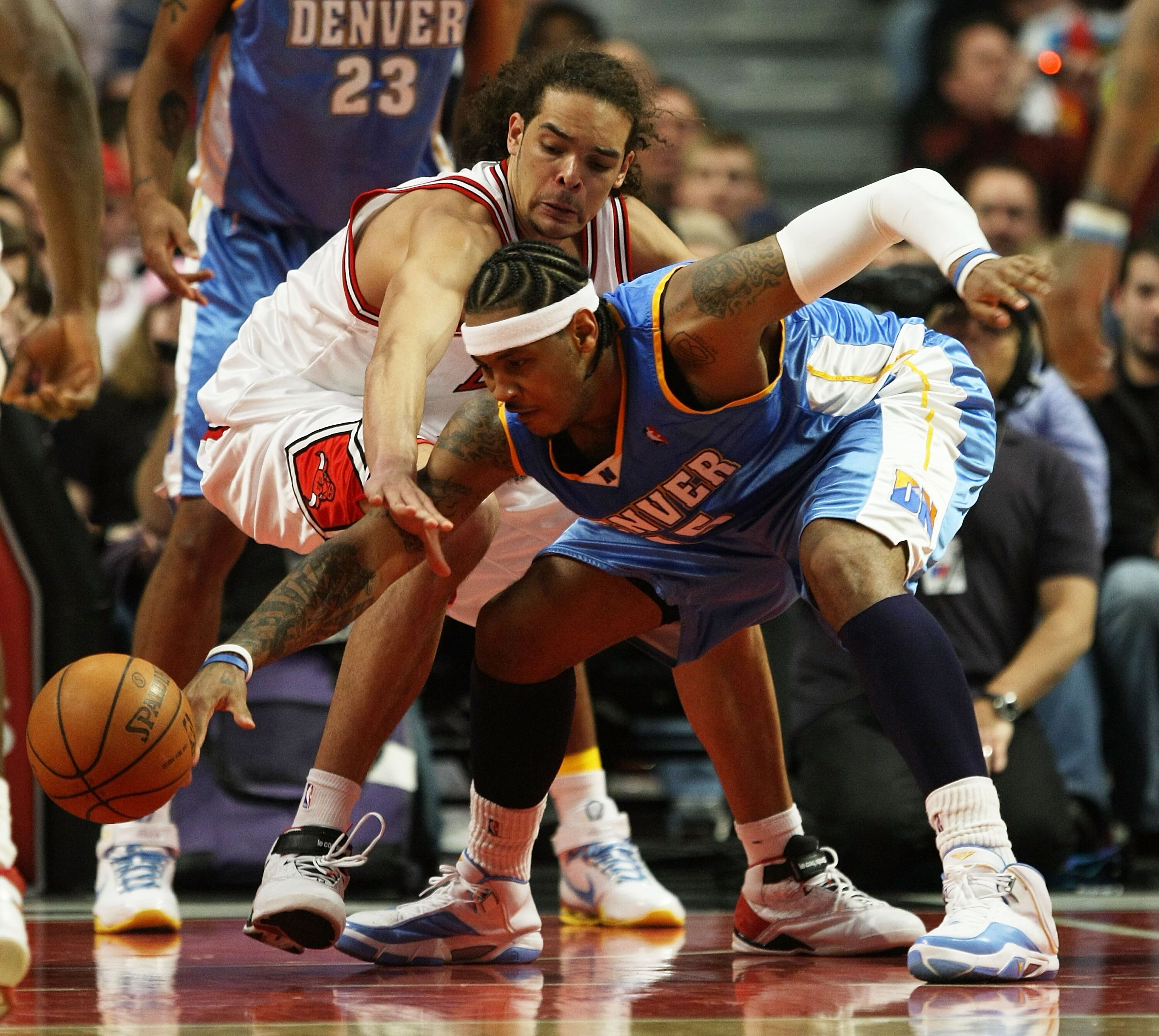 CHICAGO - FEBRUARY 22: Joakim Noah #13 of the Chicago Bulls battles for a loose ball with Carmelo Anthony #15 of the Denver Nuggets on February 22, 2008 at the United Center in Chicago, Illinois. NOTE TO USER: User expressly acknowledges and agreees that,